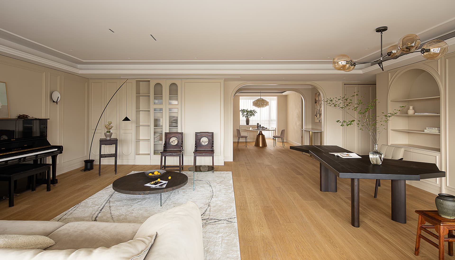 A modern living room with wooden furniture and fabric upholstery.