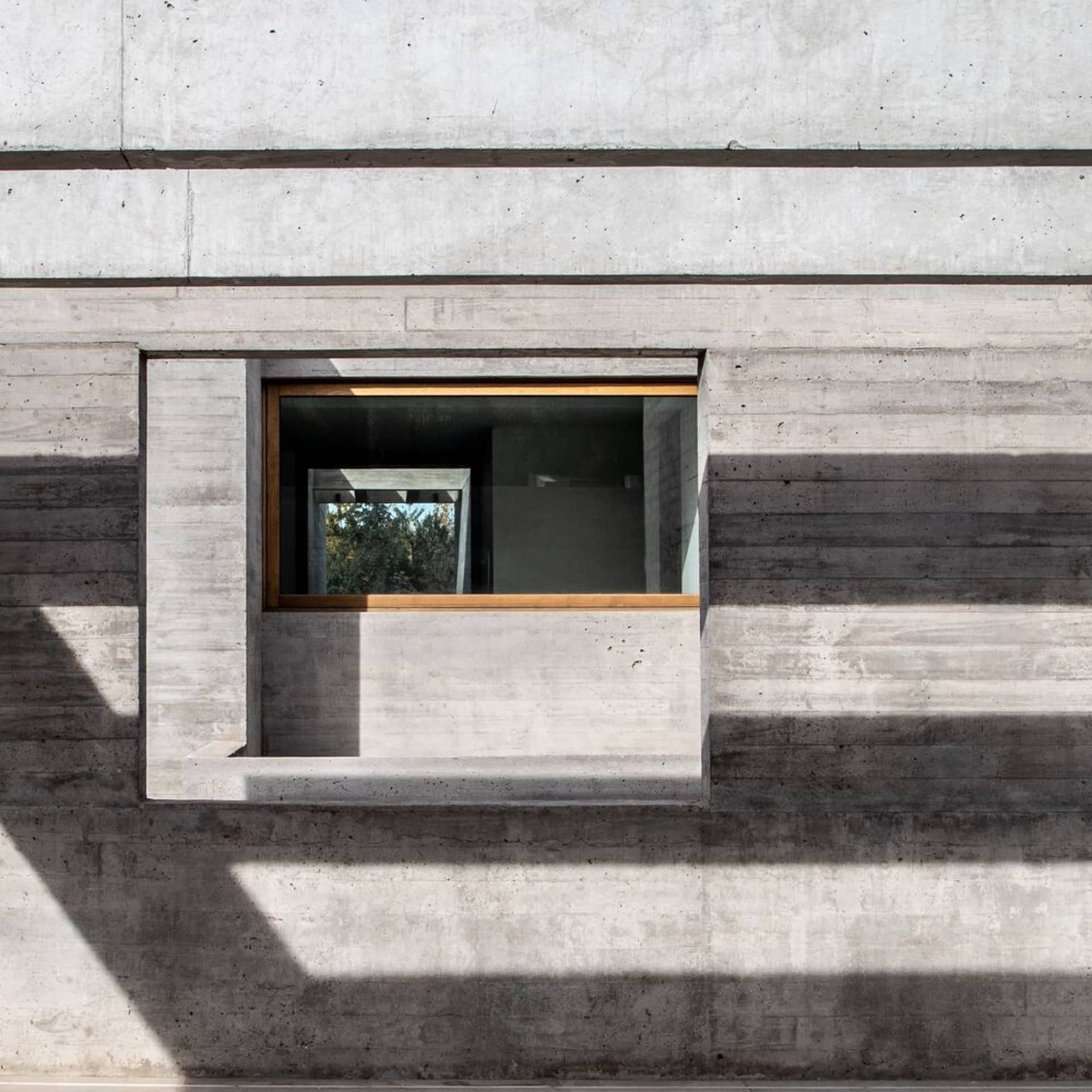 Concrete window with minimalist framing on a modern exterior wall