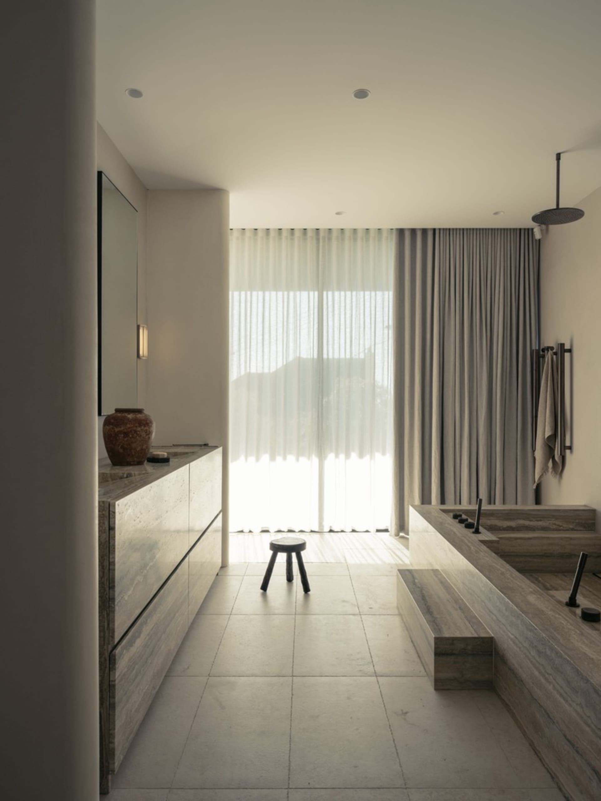 Modern bathroom featuring concrete, glass, and wood materials.
