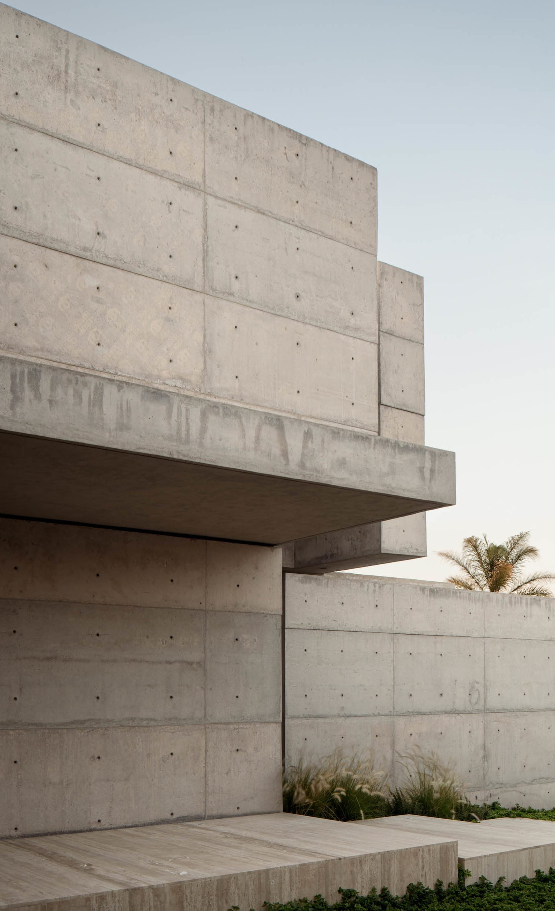 Modern building exterior featuring concrete walls and a minimalist design.