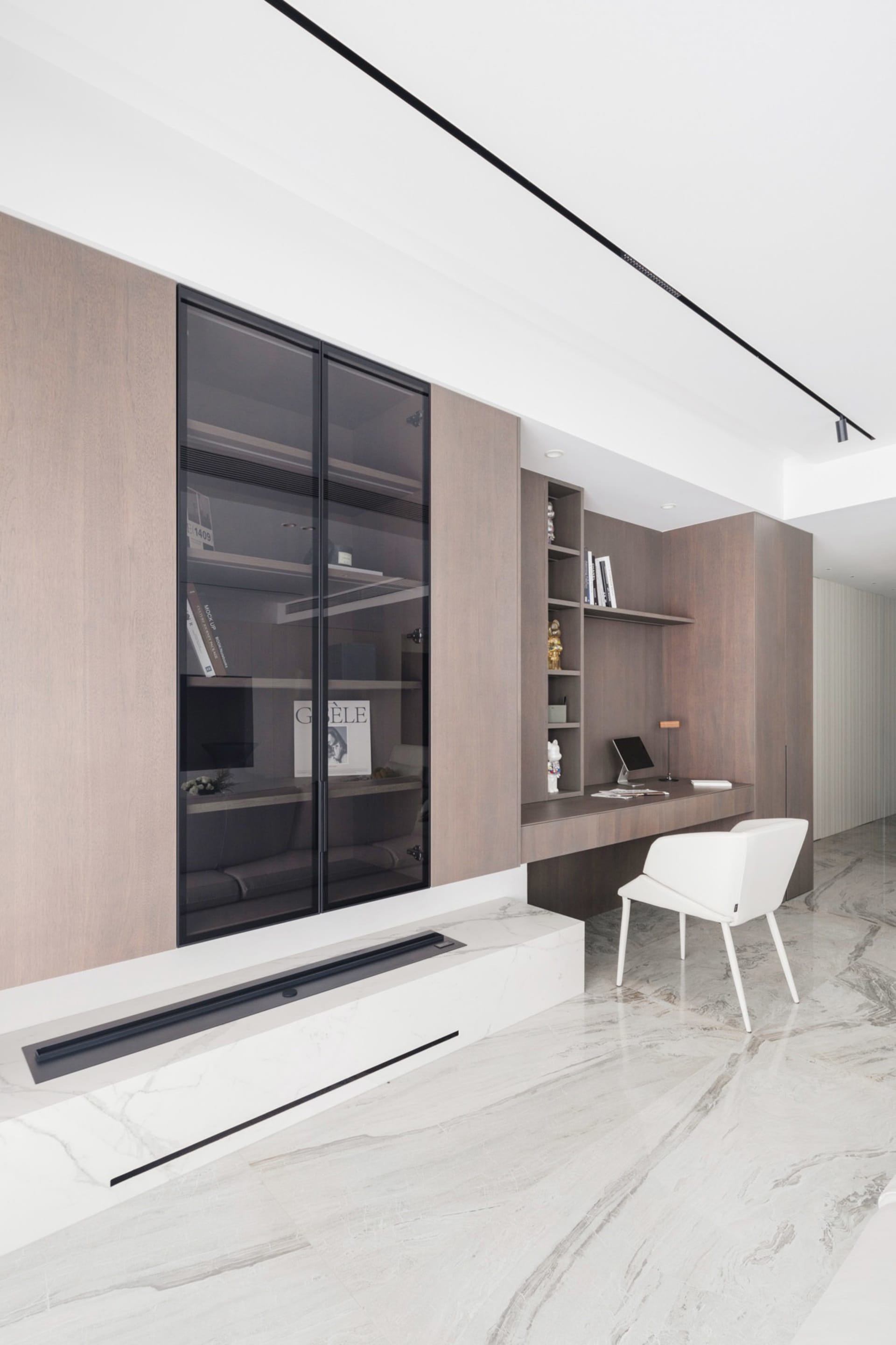 A modern office space featuring wood, glass, and marble materials.