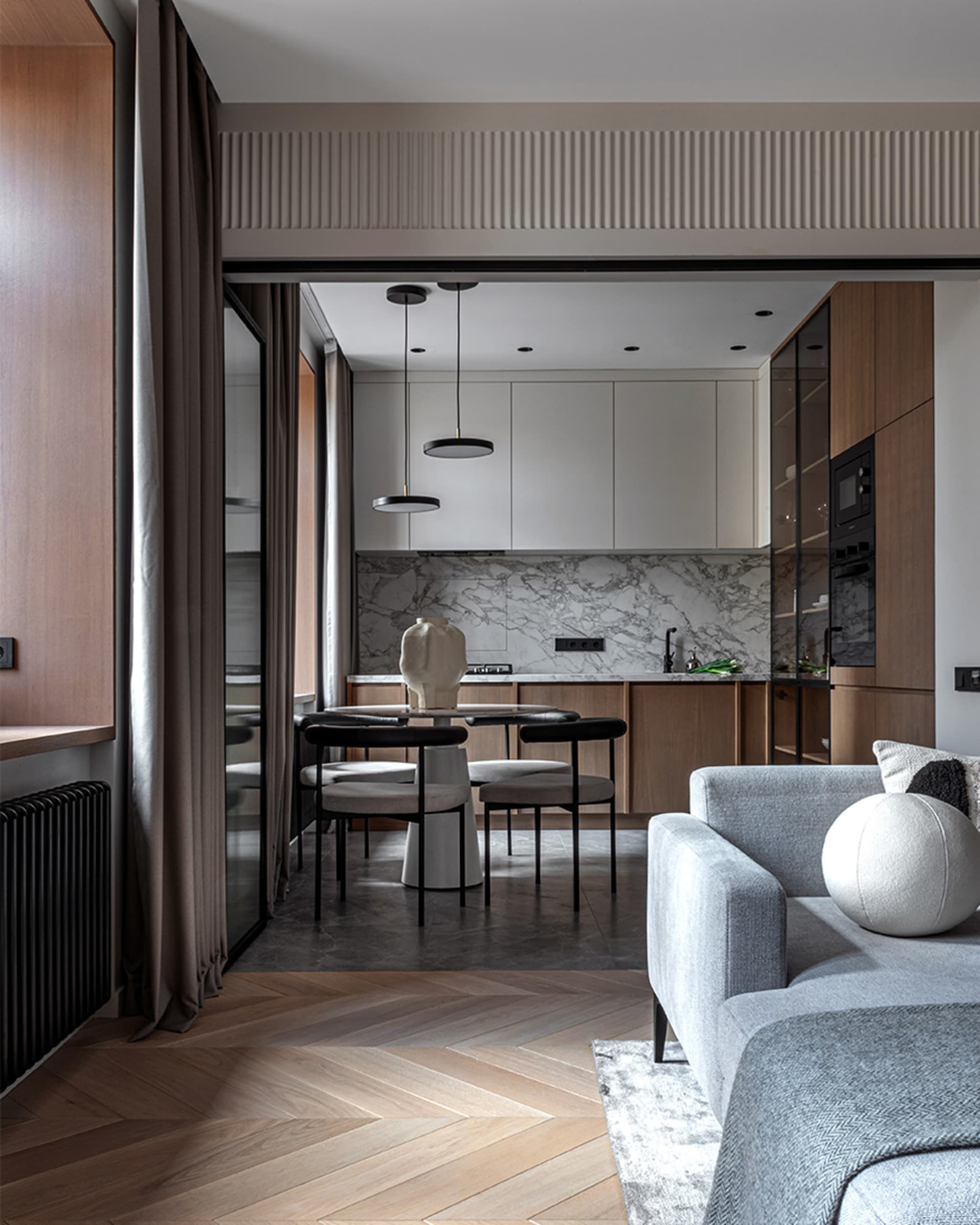 A modern apartment featuring a cooking space with wooden furniture.