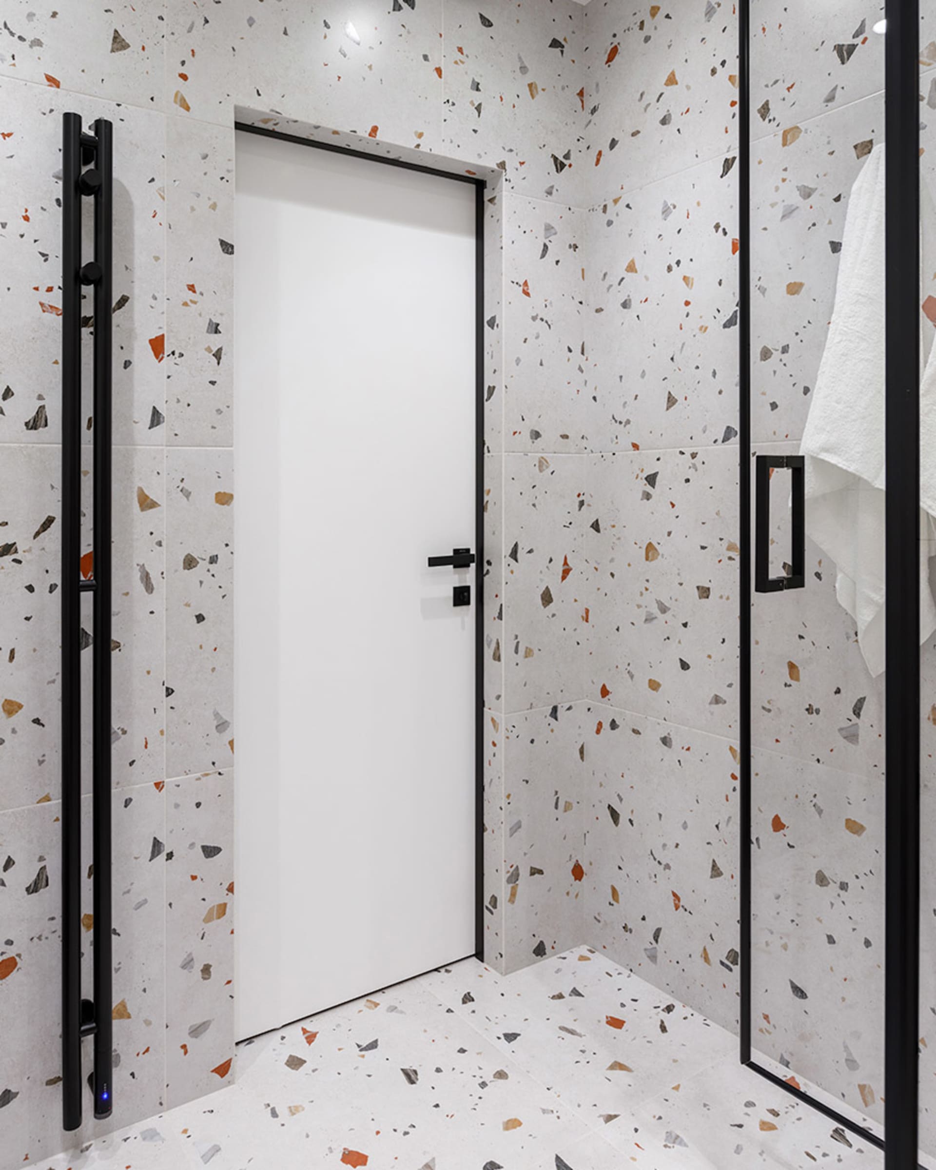 A modern bathroom with terrazzo tiles on the walls and floor