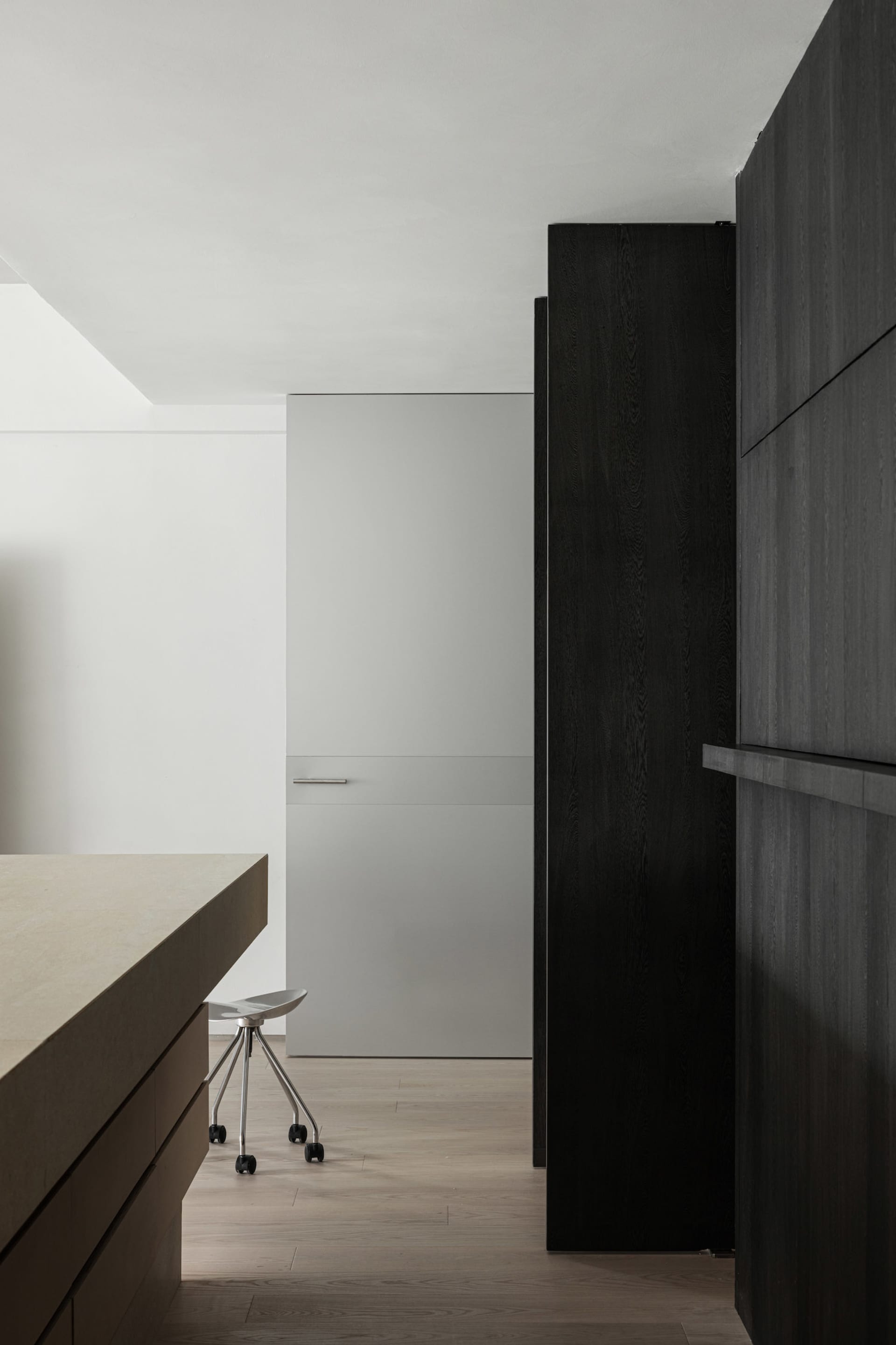 Modern kitchen with wooden cabinets and flooring.