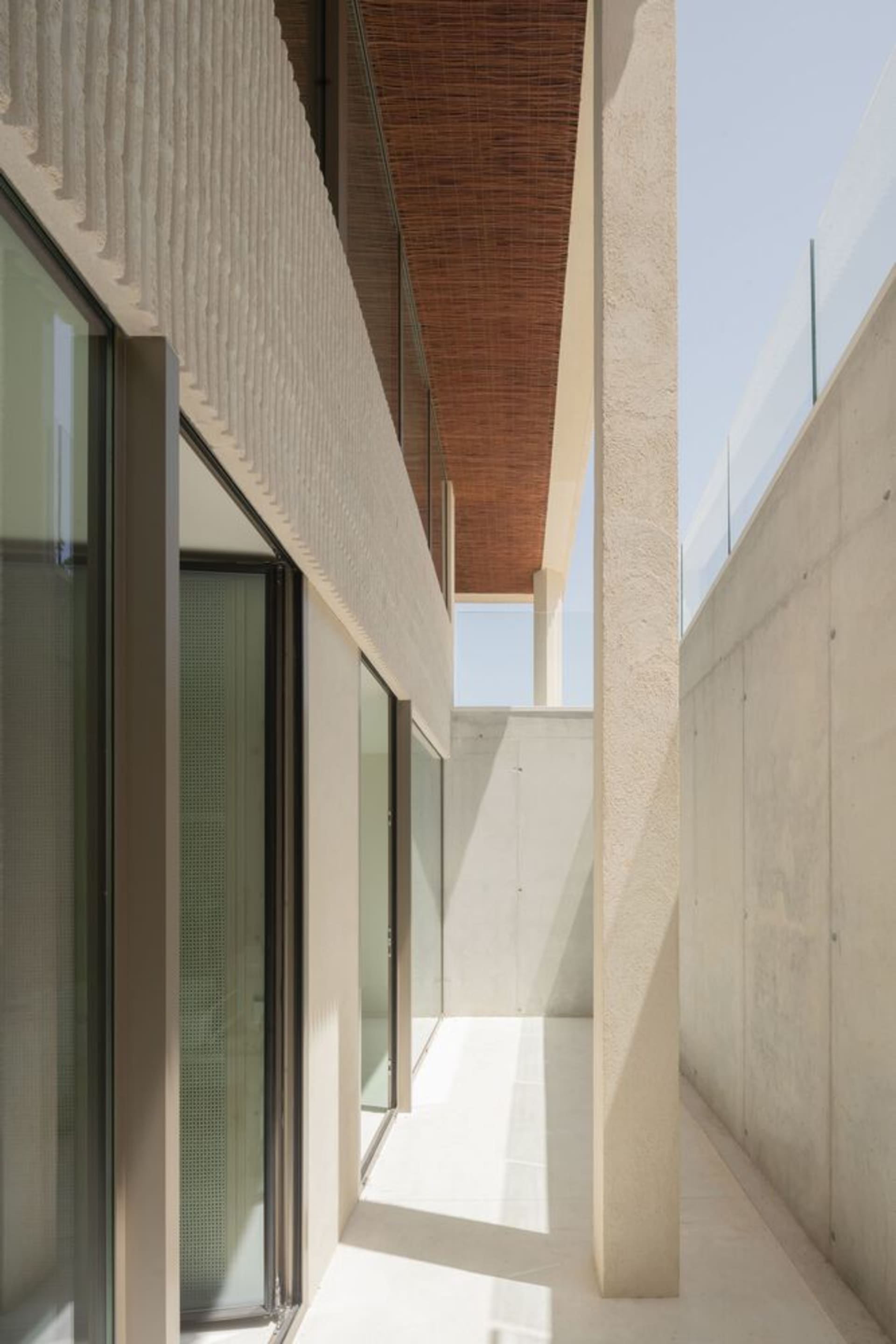 An exterior architectural design featuring concrete and glass elements.