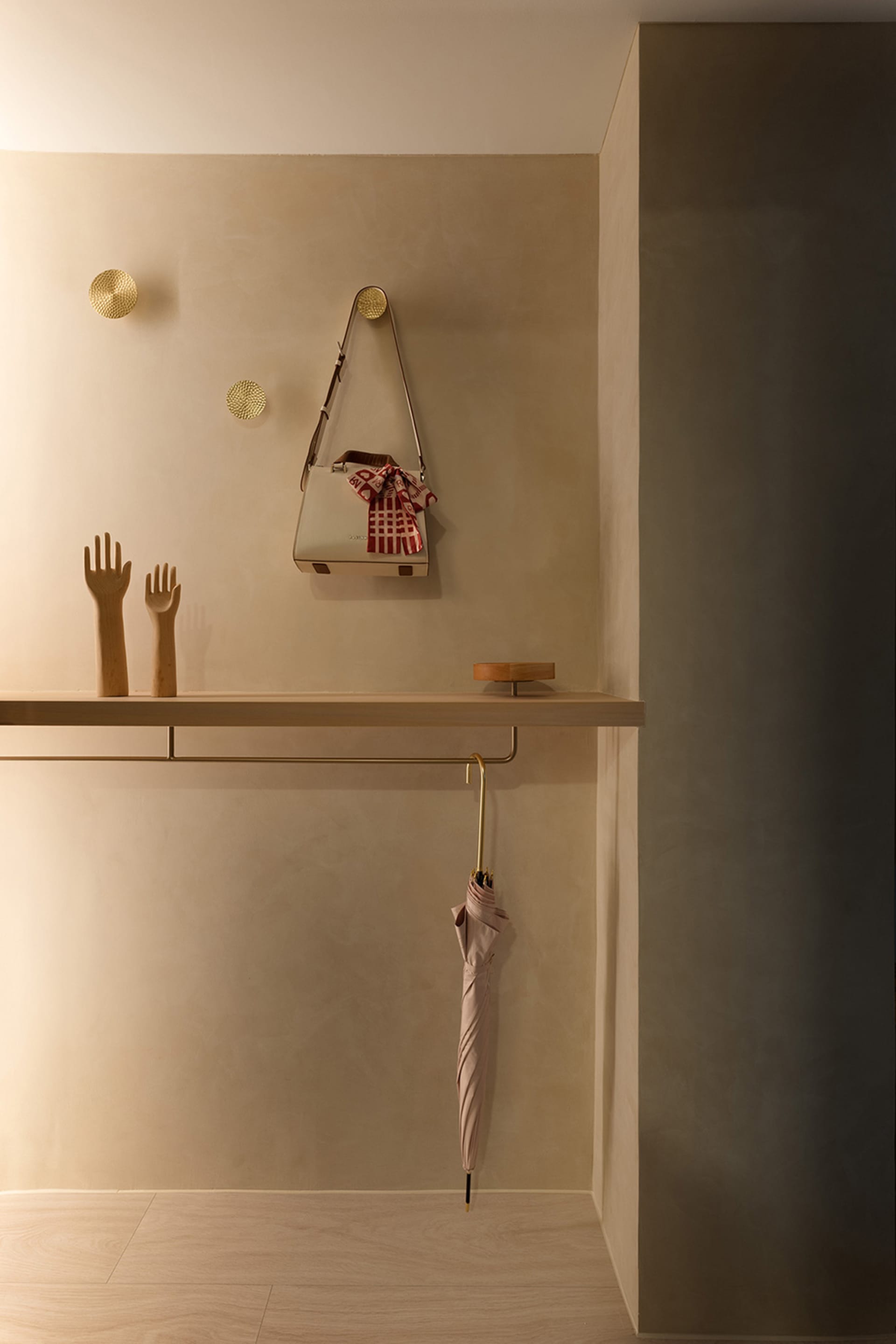 Modern entryway featuring a floating shelf with a handbag and umbrella