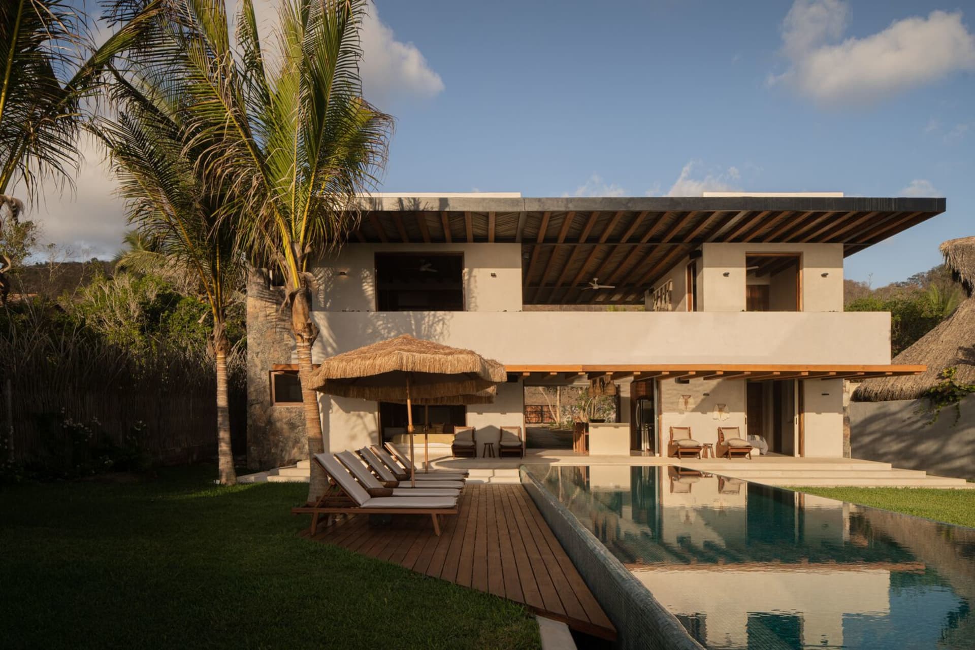 Modern residential exterior with minimalist design, featuring sustainable wood and concrete materials, and minimalist furnitu