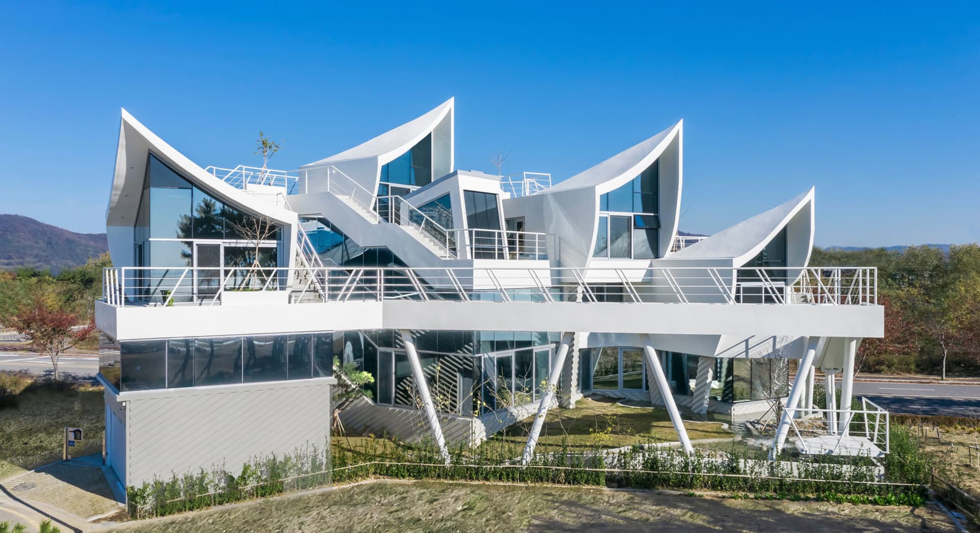 A modern building with a glass exterior and a white facade.