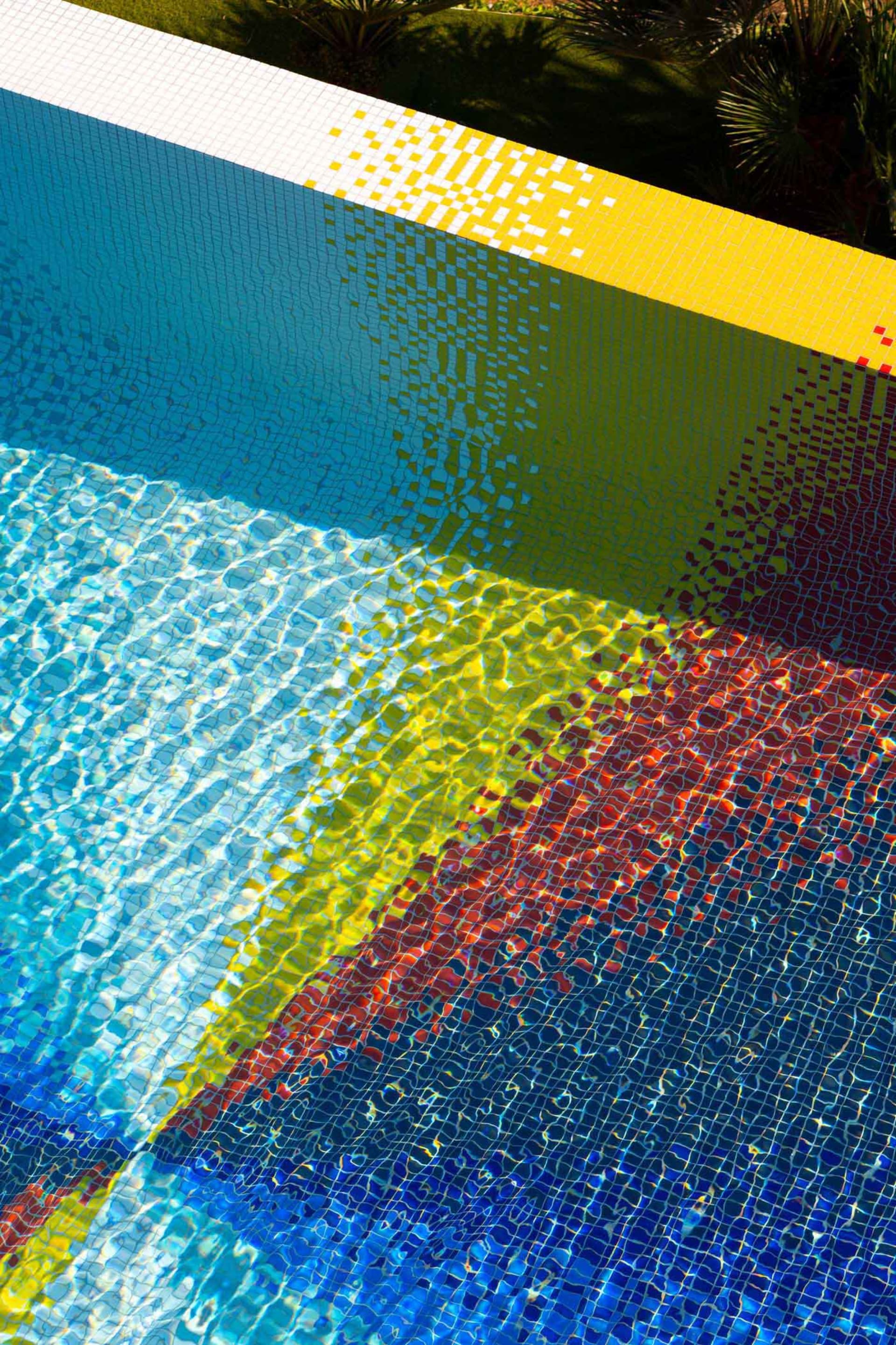 A vibrant, tiled poolside area with colorful gradients.