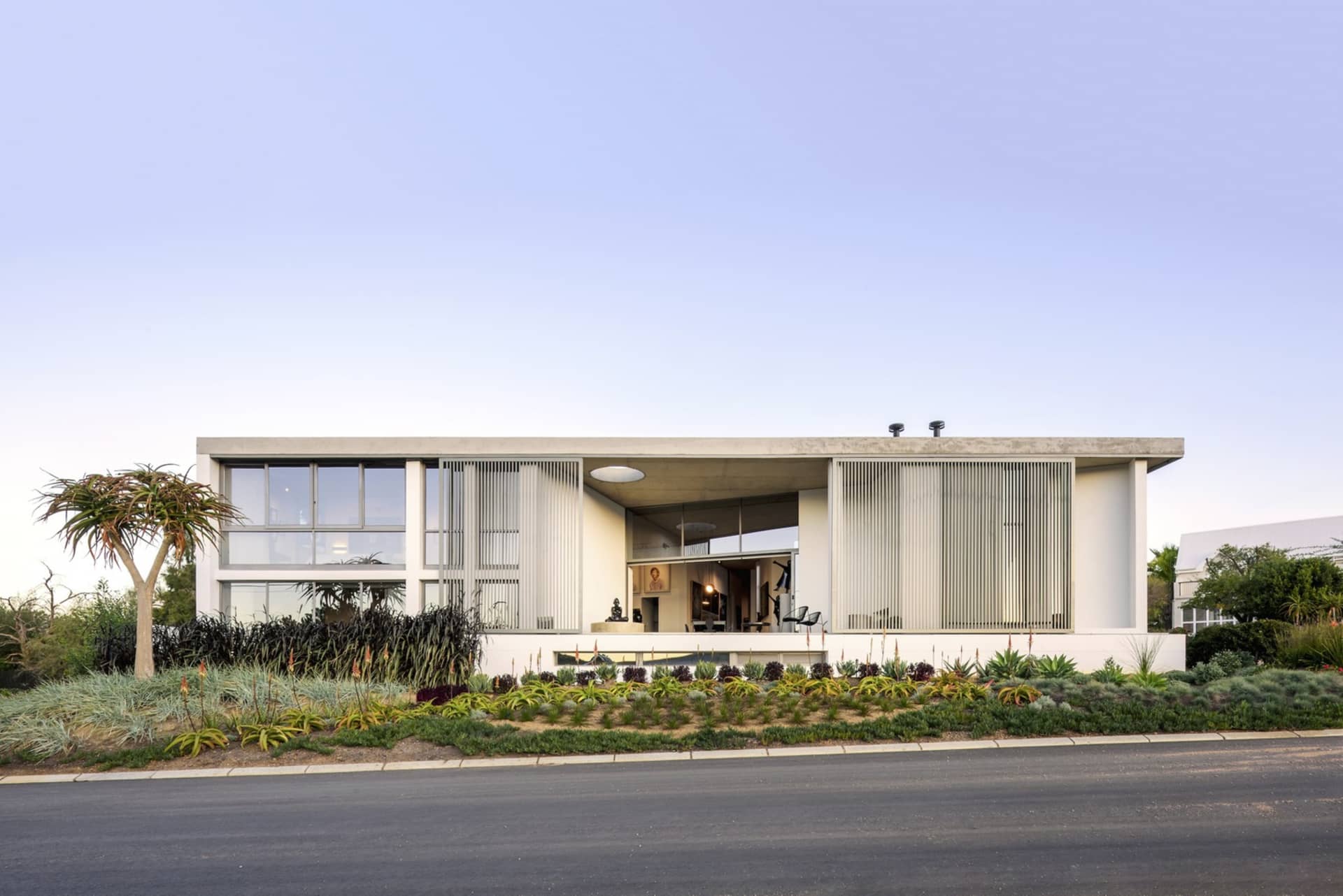 Modern residential home with concrete, glass, and metal materials.