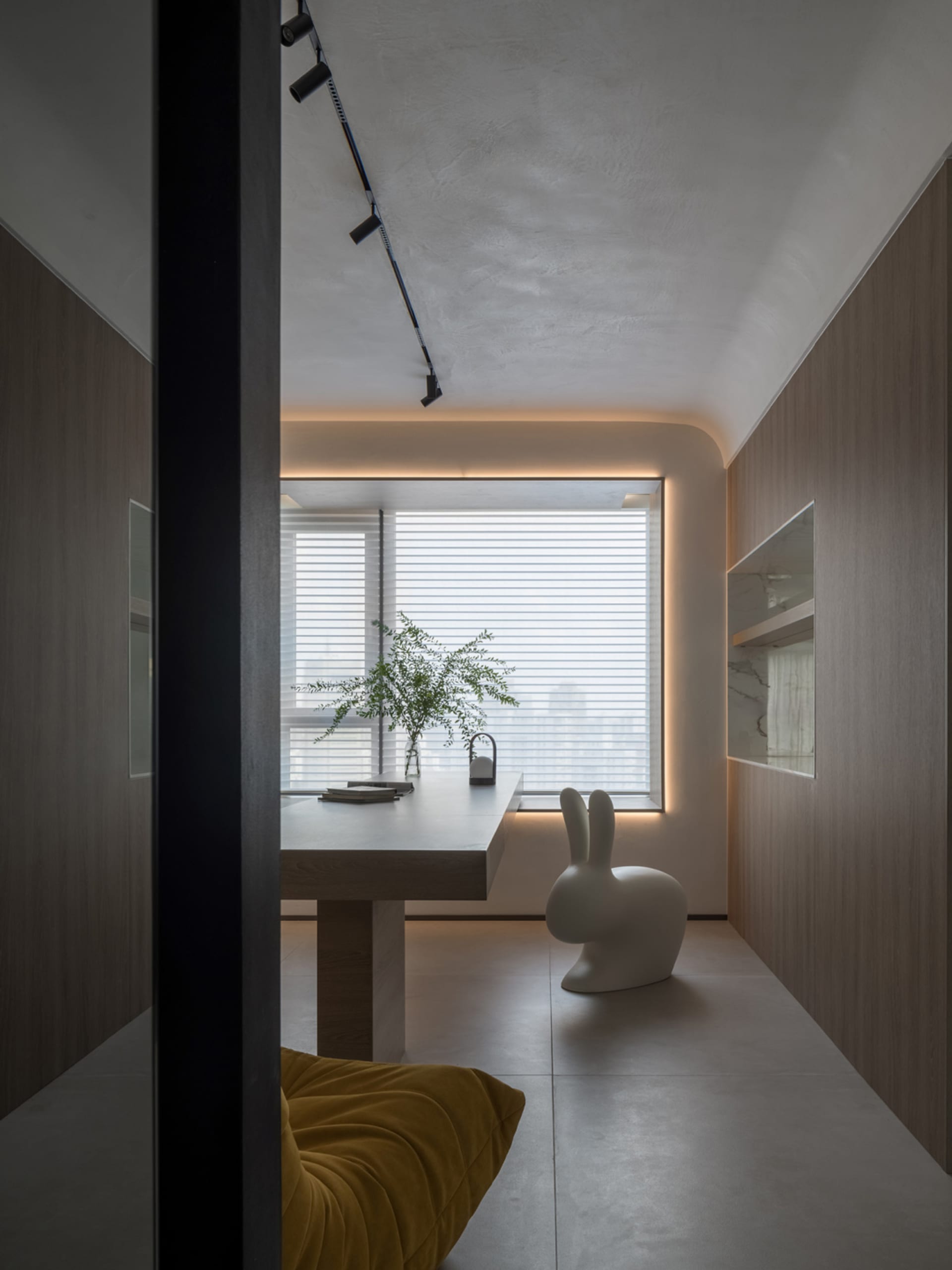 Contemporary home office featuring minimalist design with wooden and marble elements.