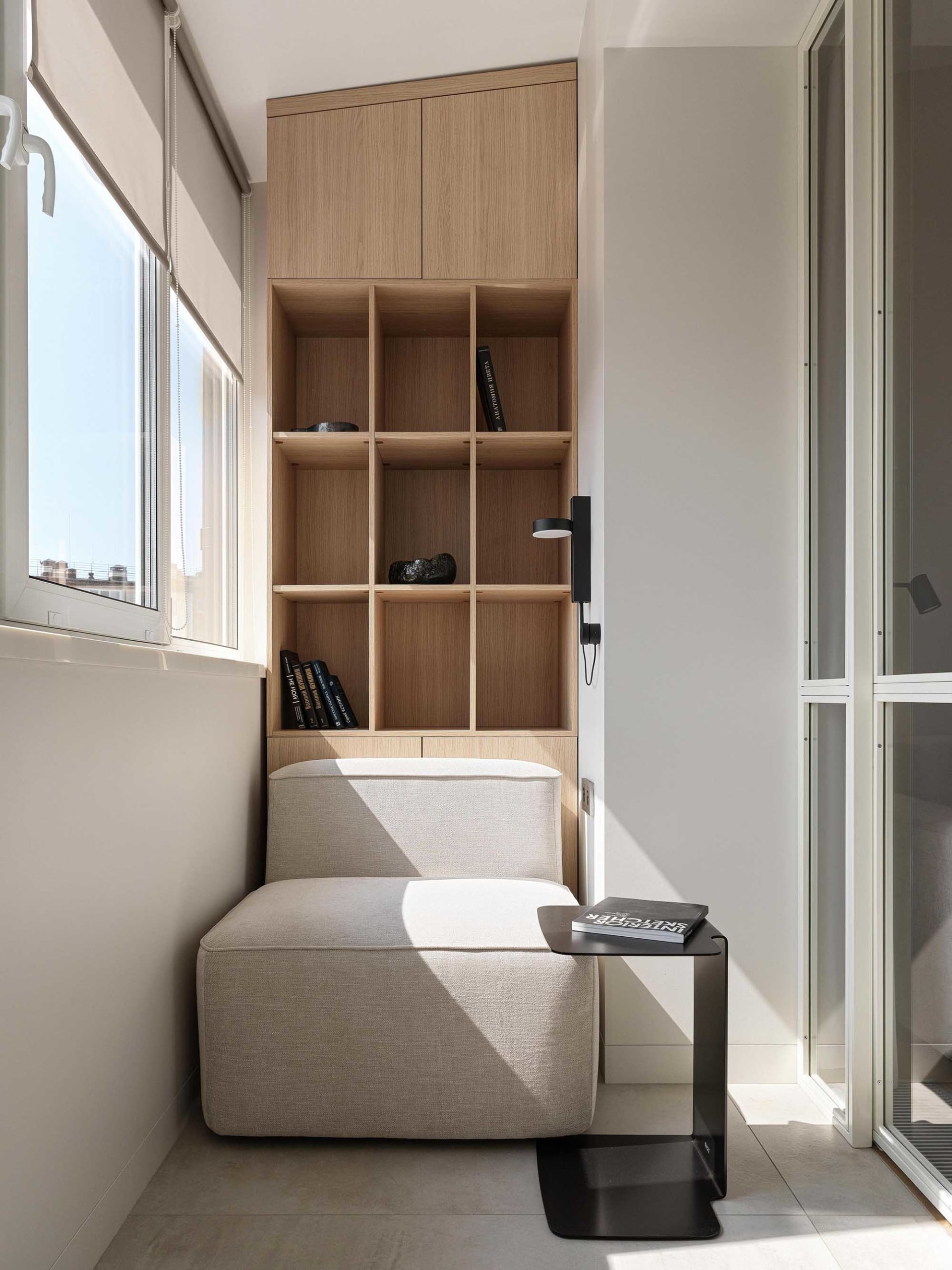 A minimalist living room featuring a wooden cabinet with shelves.
