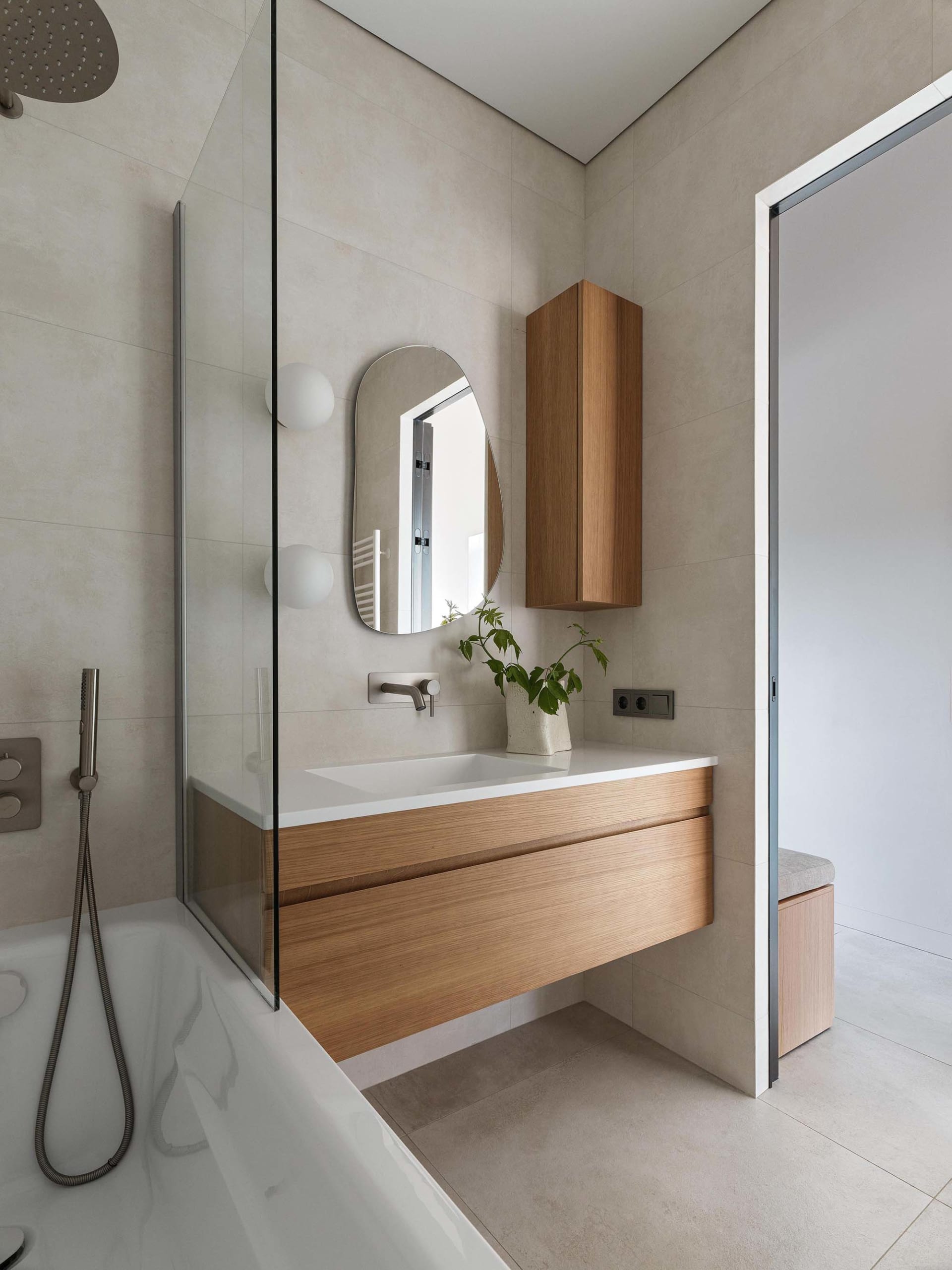 A modern bathroom featuring concrete and wooden elements.