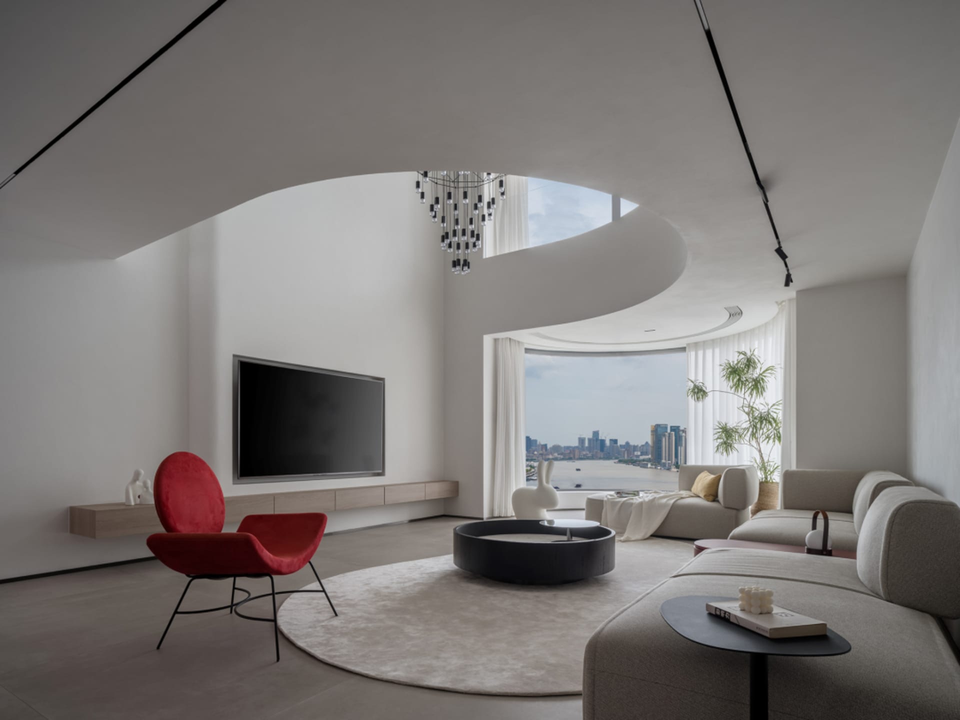 A modern, minimalistic living room features a sleek, grey sectional sofa, a black geometric chandelier, and white curtains, c