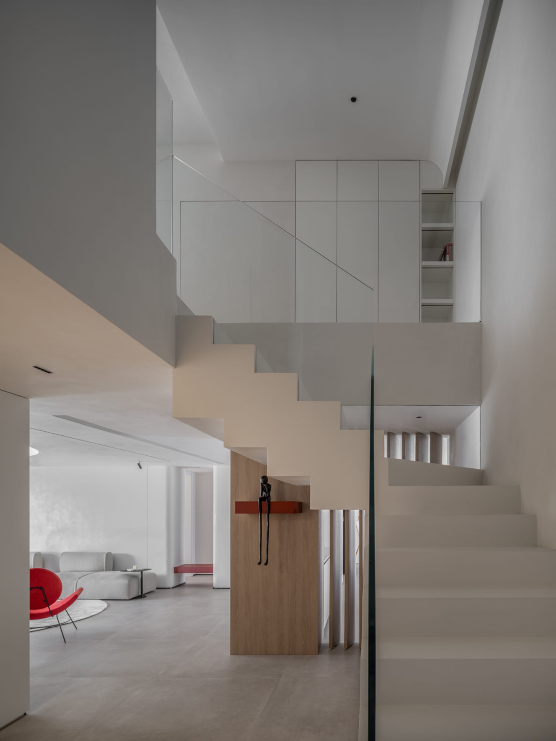 A modern apartment interior featuring concrete stairs and a minimalist design.