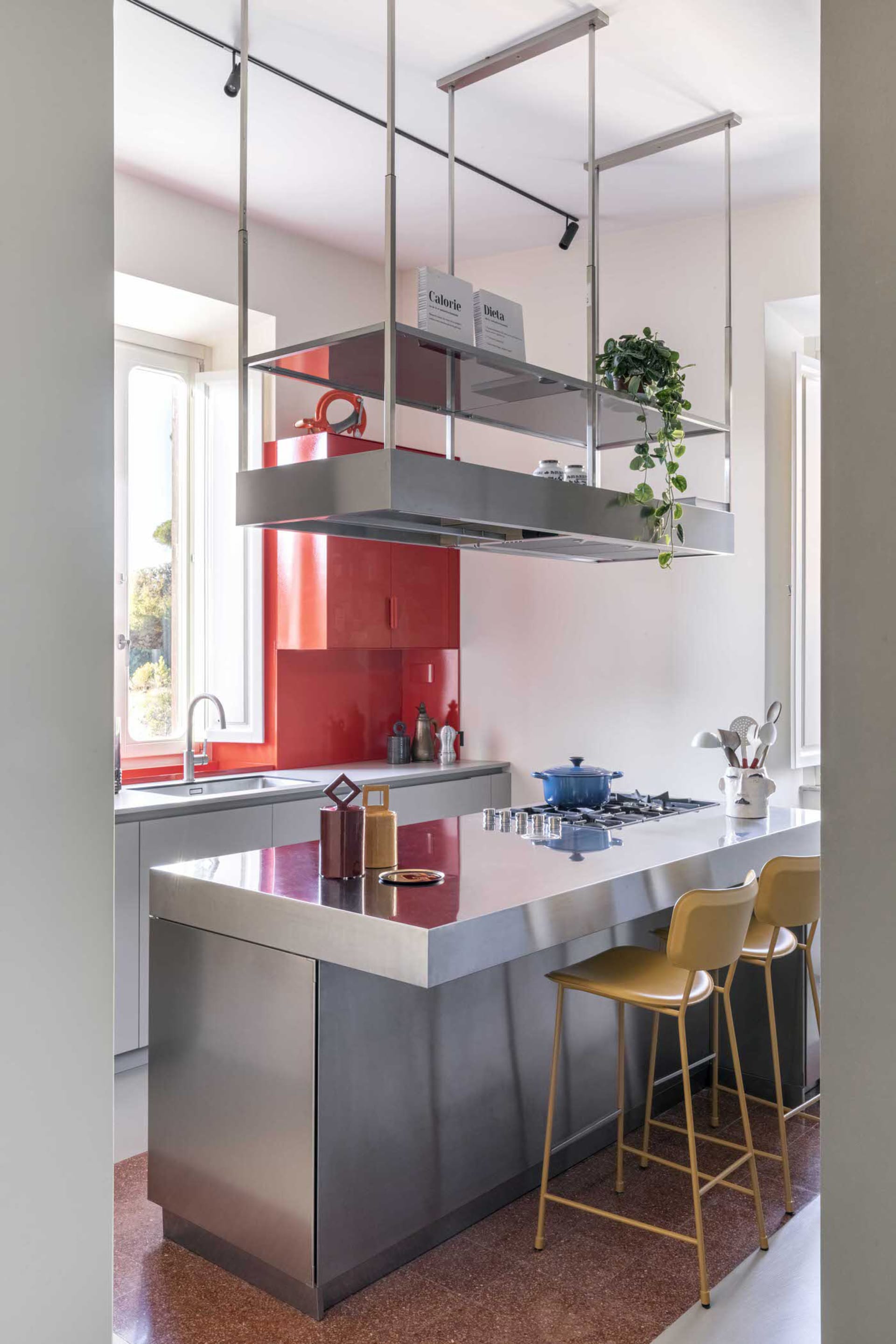Modern minimalist kitchen with metallic accents and stainless steel appliances