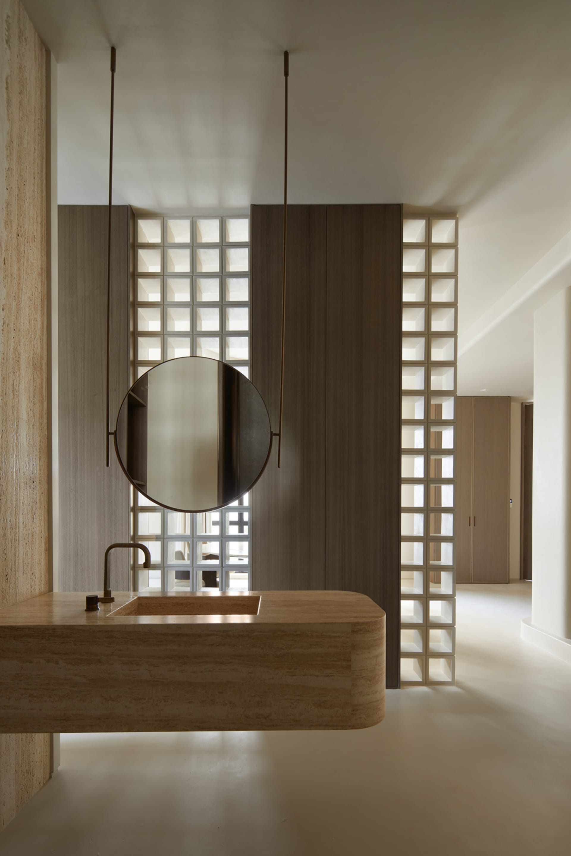 A modern minimalist bathroom featuring a marble sink and wooden accents.