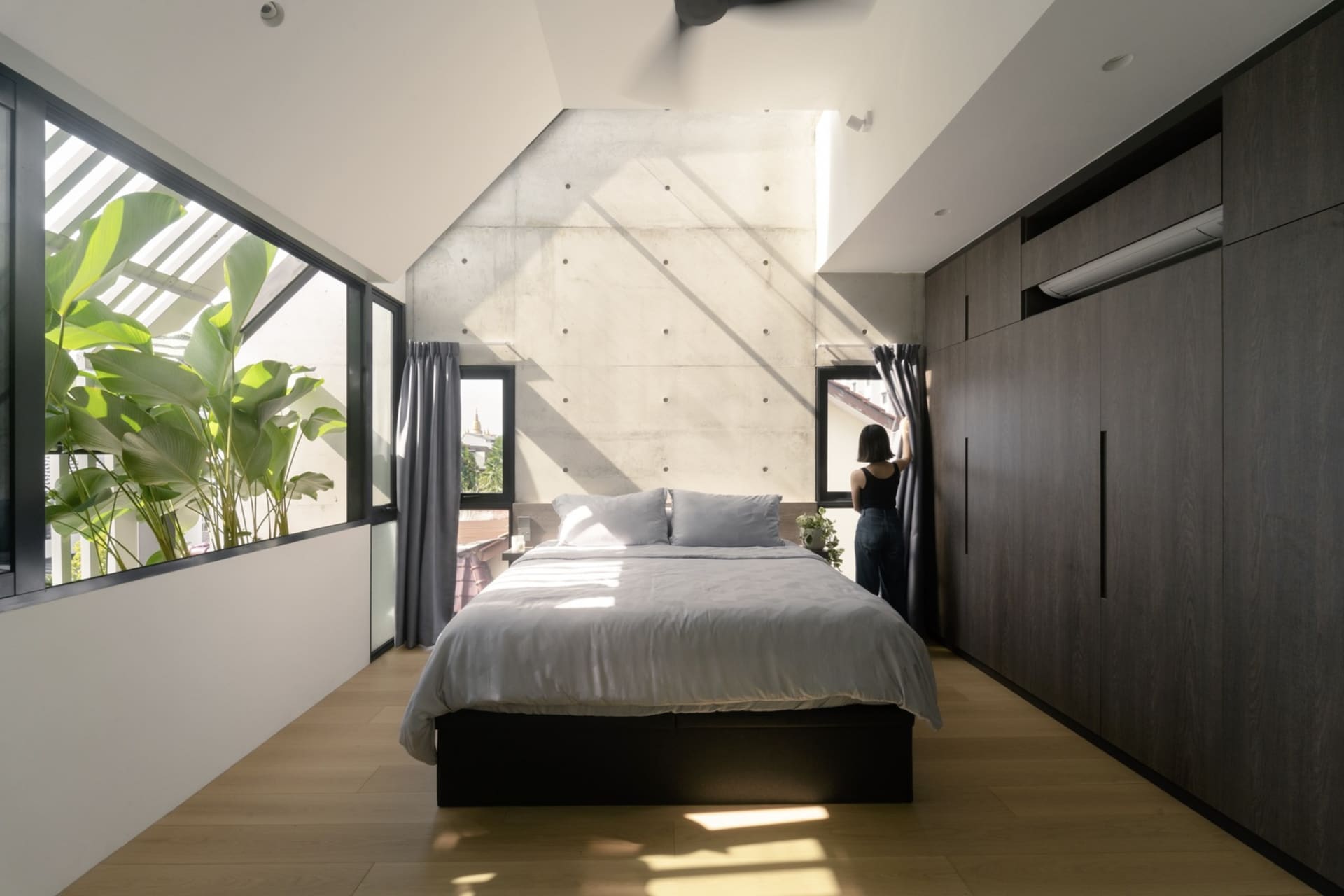 Modern minimalist bedroom featuring minimalist design with concrete and wooden elements