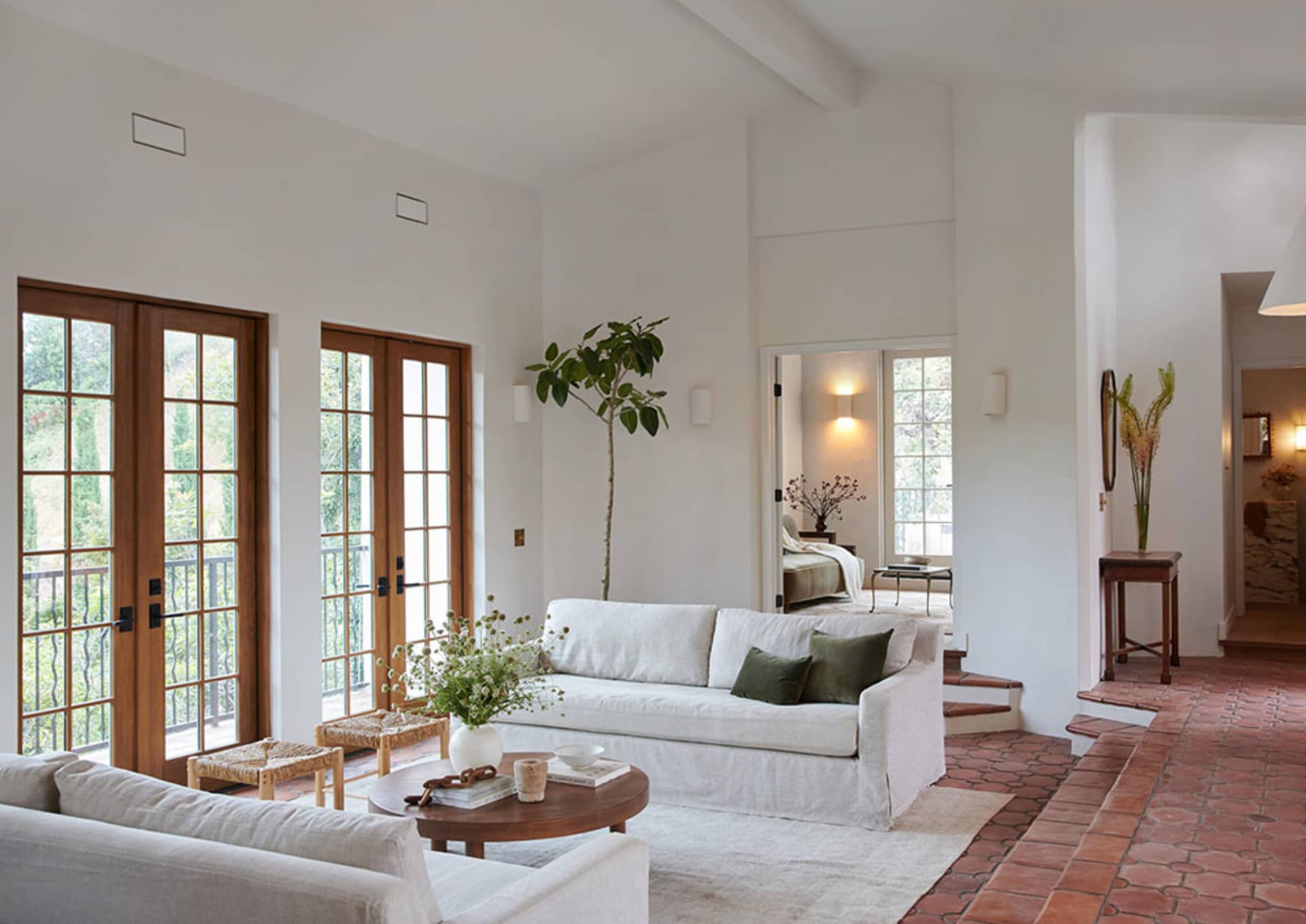 A minimalist living room with natural fibers, concrete, and wooden elements.