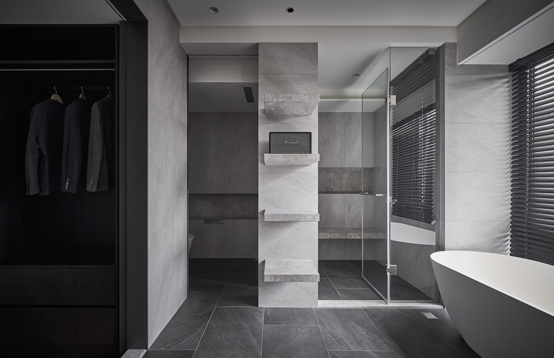 Modern bathroom featuring marble and stone materials with a walk-in shower and freestanding tub.