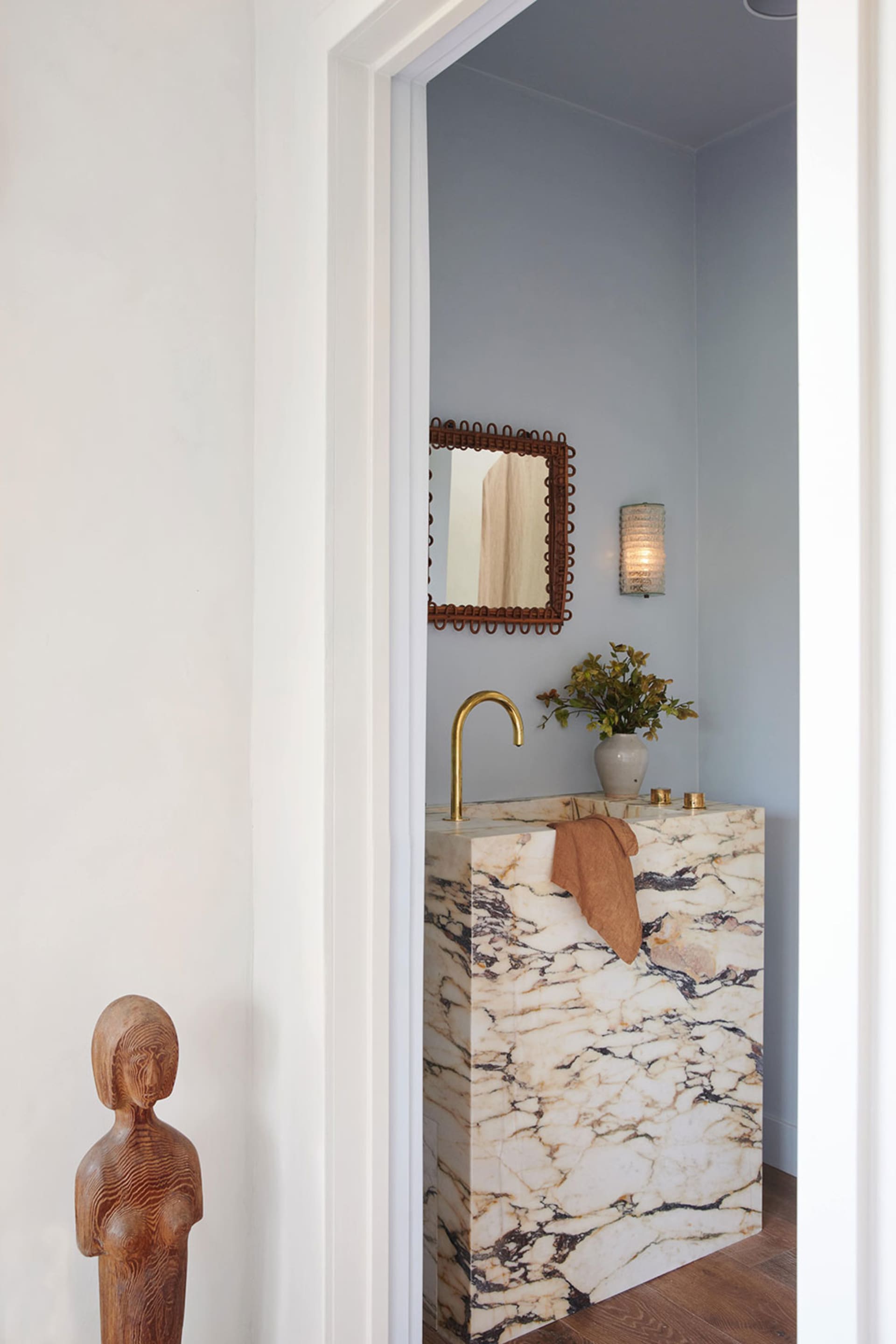 A modern bathroom with a marble countertop and a minimalist design.
