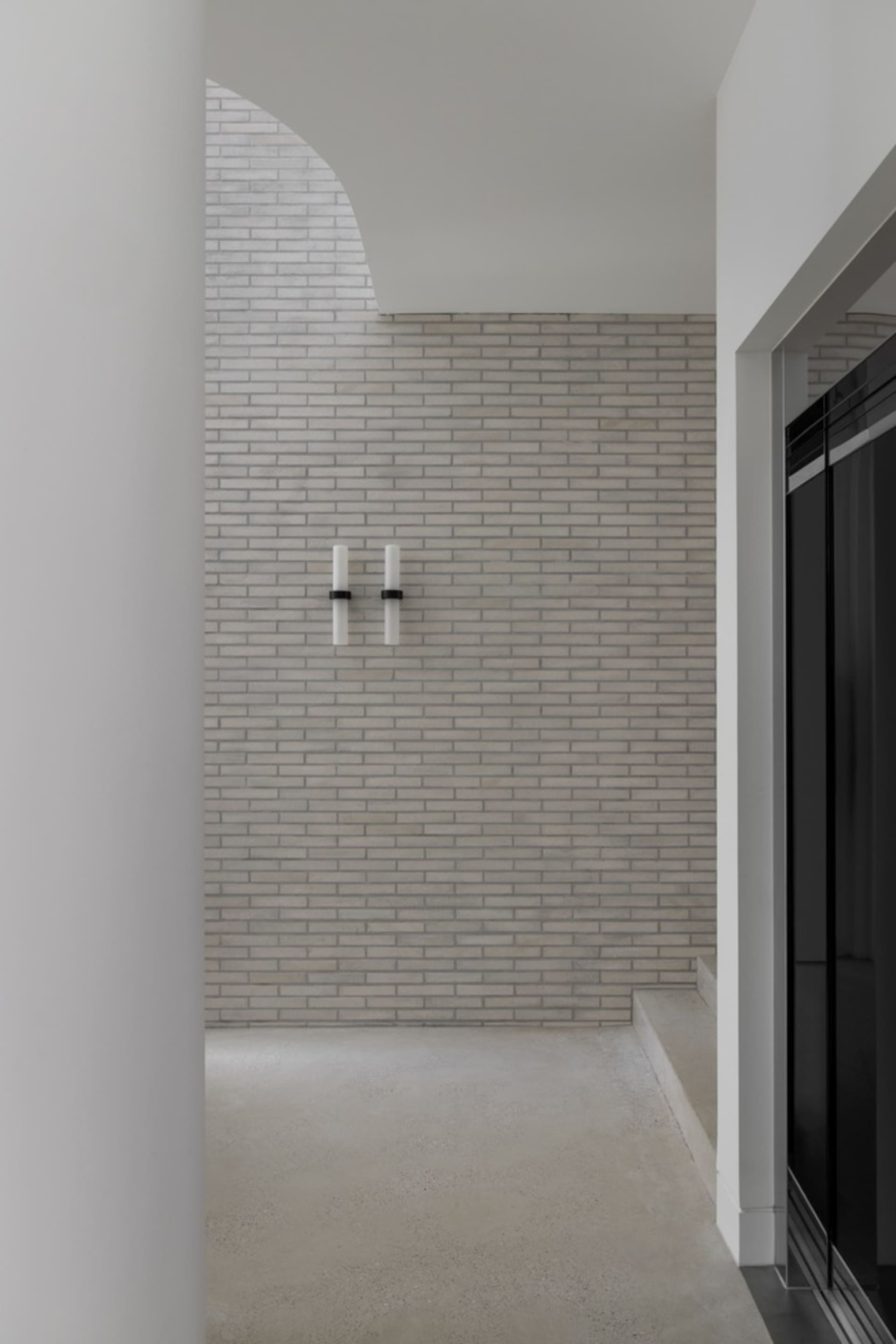 Minimalist interior design featuring brick and concrete materials