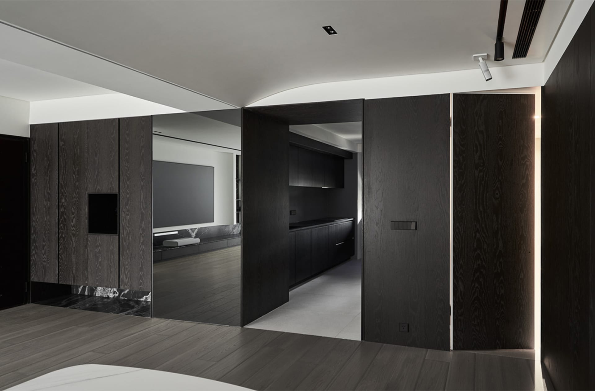 Interior design of a modern living space featuring black wood finishes and a minimalist aesthetic.