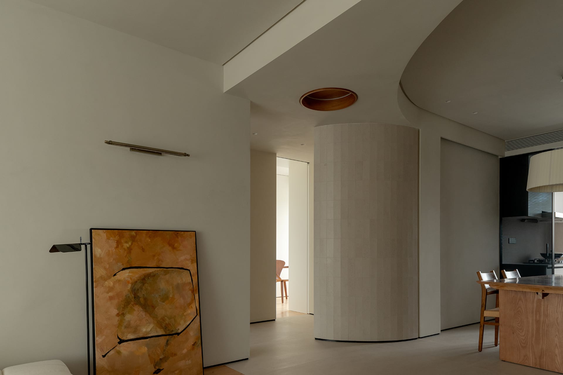 Modern living room featuring a concrete cylinder and minimalist decor
