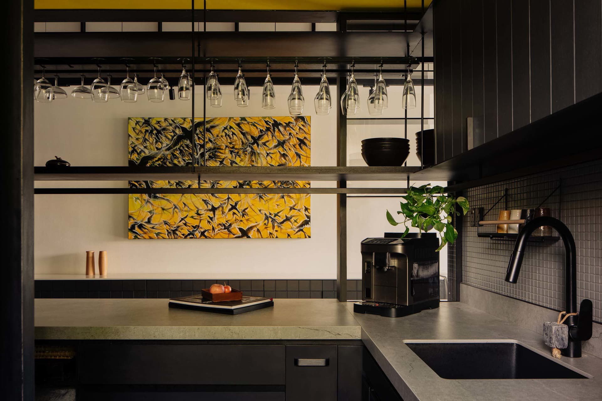 Modern industrial kitchen with concrete countertops, metal accents, and minimalist design.