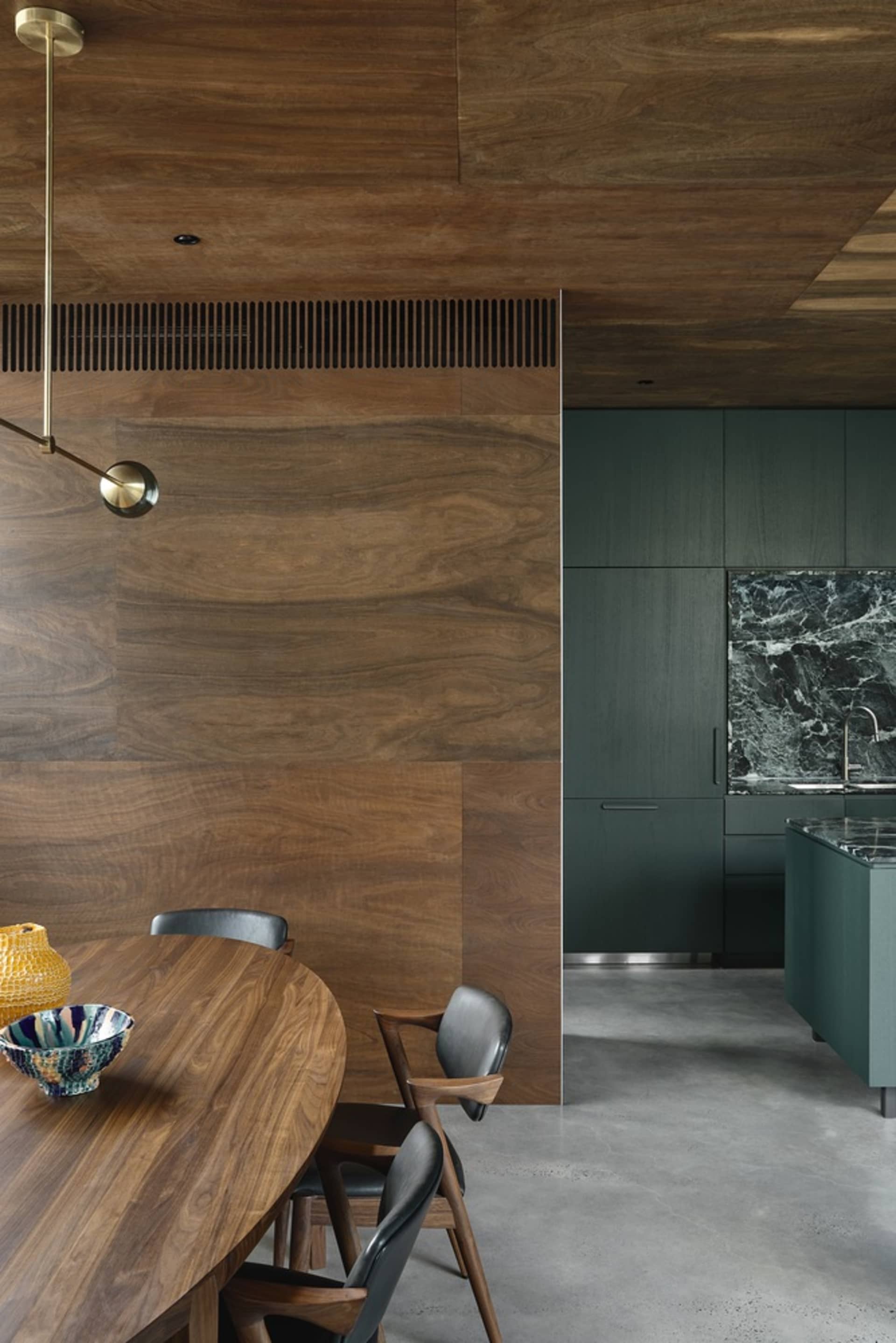 A modern minimalist interior featuring wooden flooring, walls, and furniture.