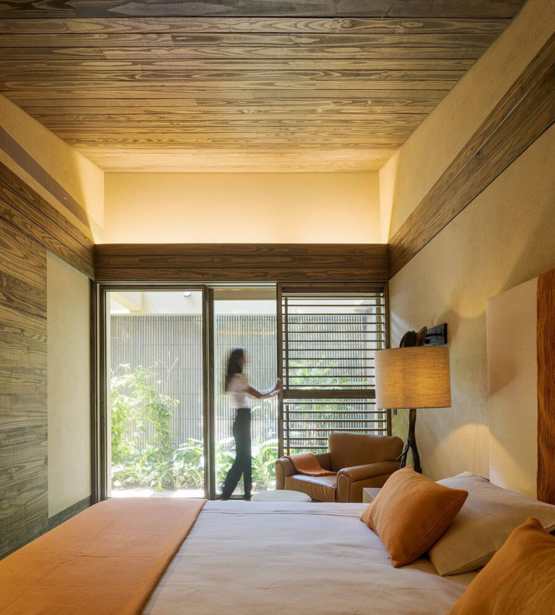 A modern bedroom suite featuring wood elements and natural light.