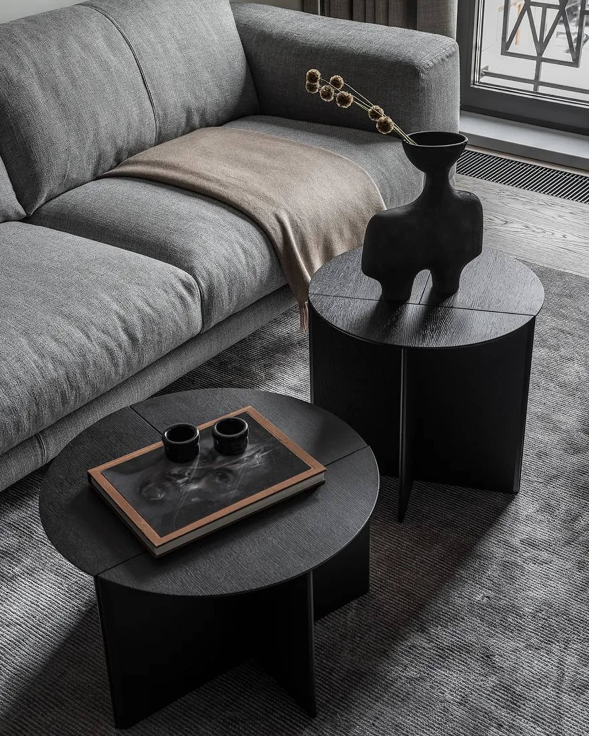 Modern living room featuring black side tables with minimalist design.