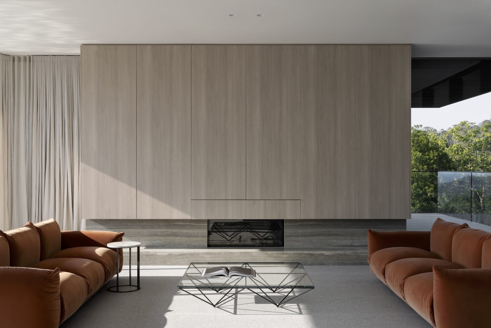 Modern living room featuring a large wooden panel wall with a fireplace and two couches.