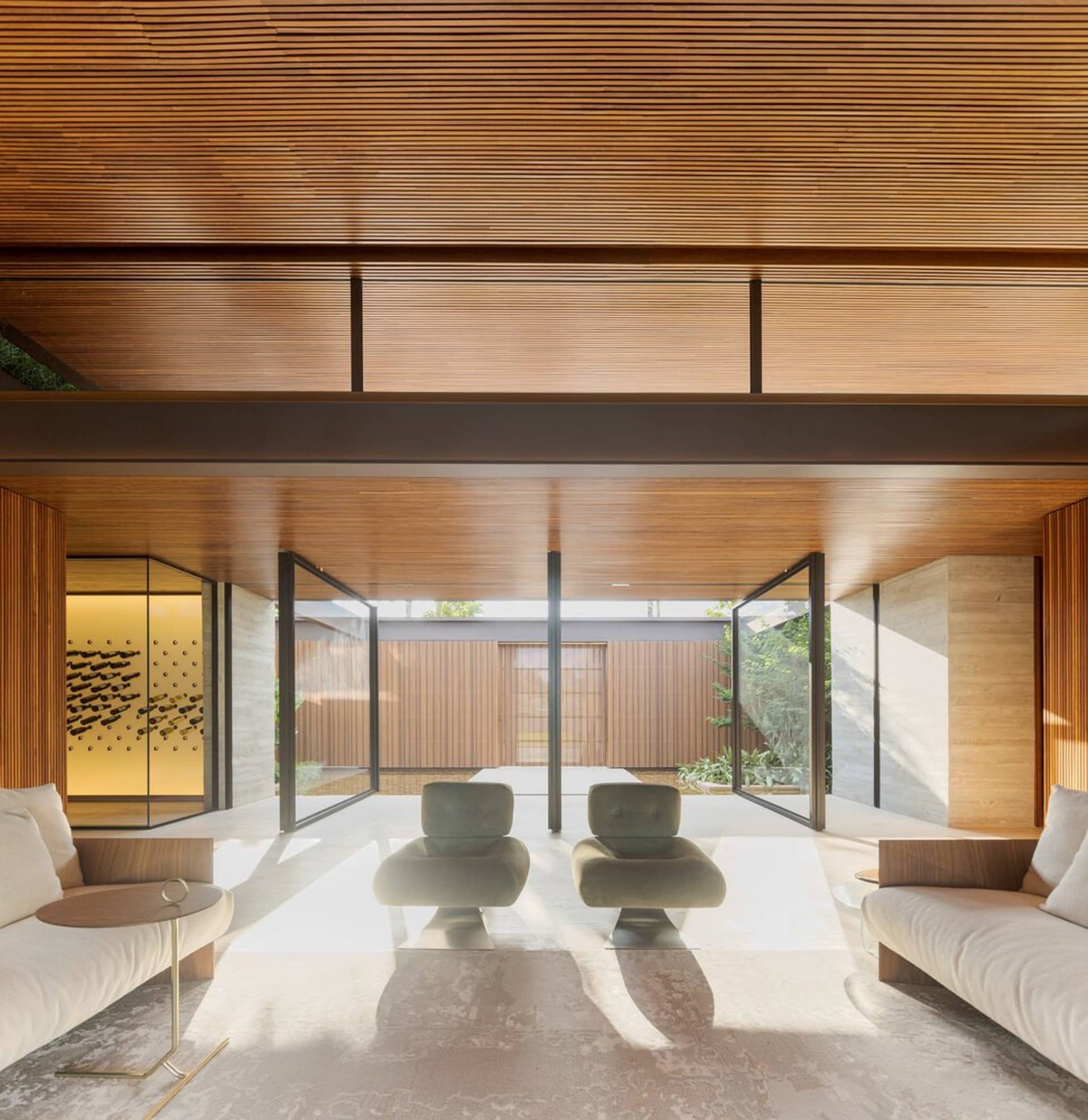 A modern living room featuring wooden walls and furniture.