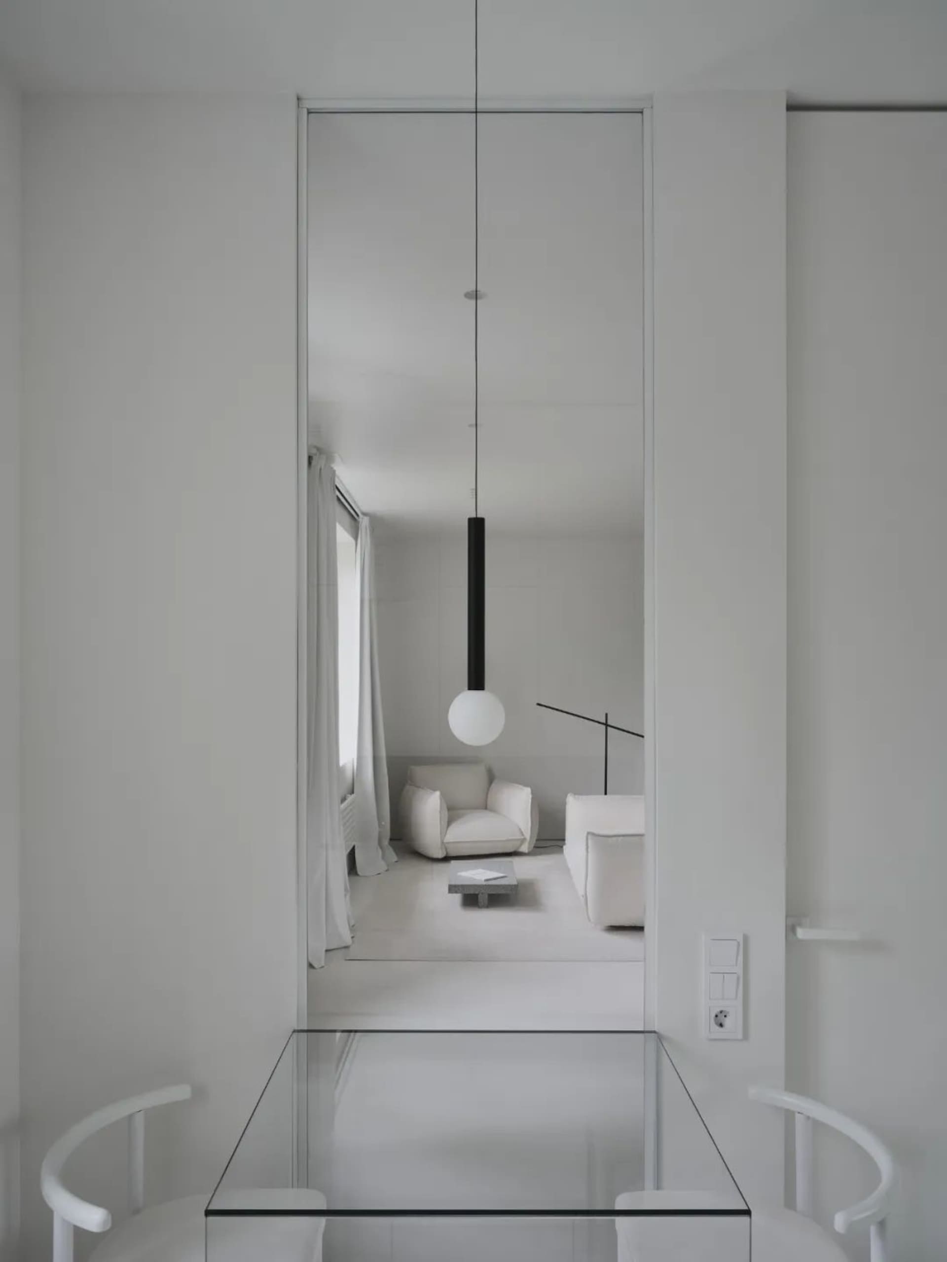 Minimalist dining room with a glass floor and wall.