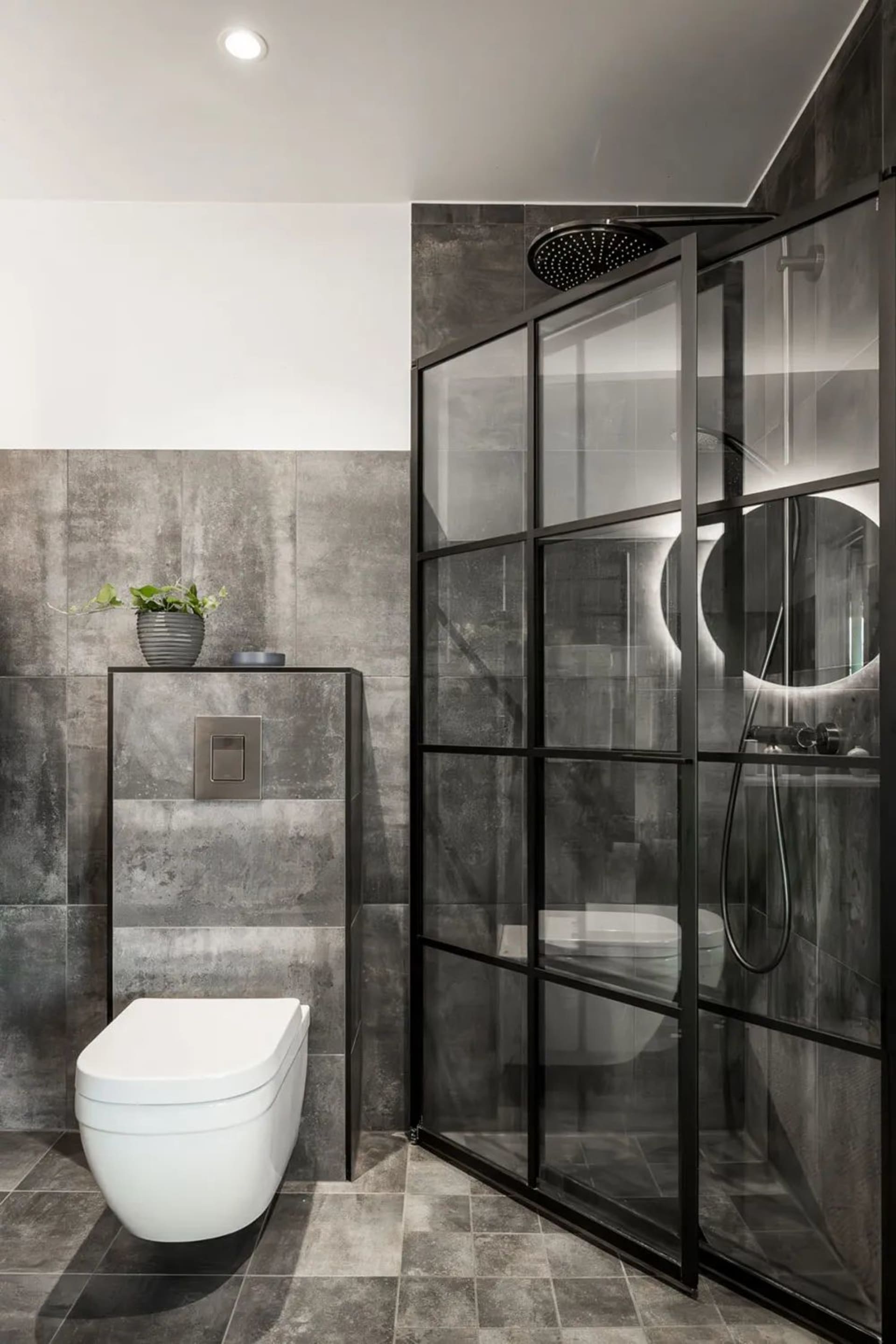 Modern minimalist bathroom with concrete tiles and a white toilet.