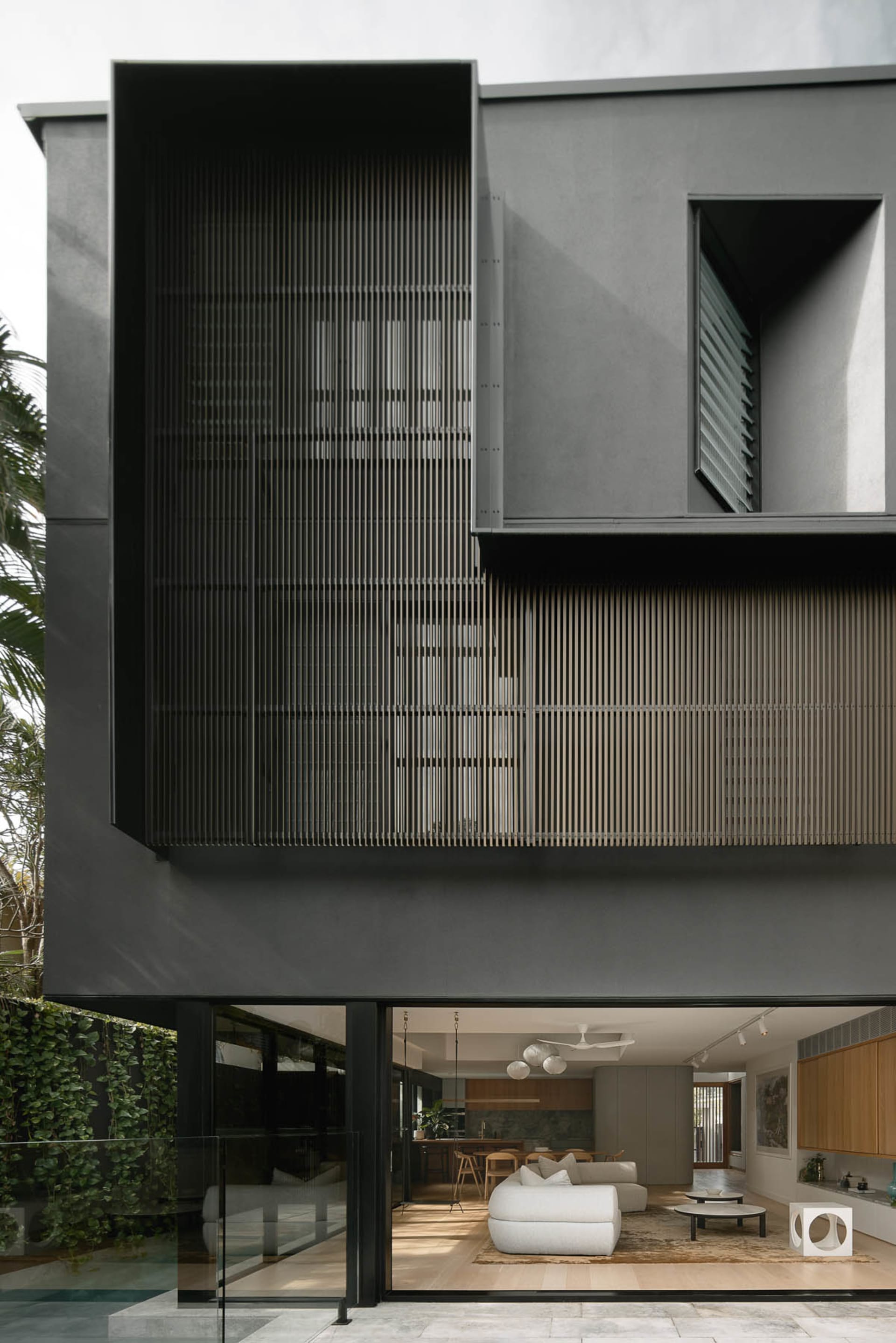 A modern residential architecture with a metal screen facade