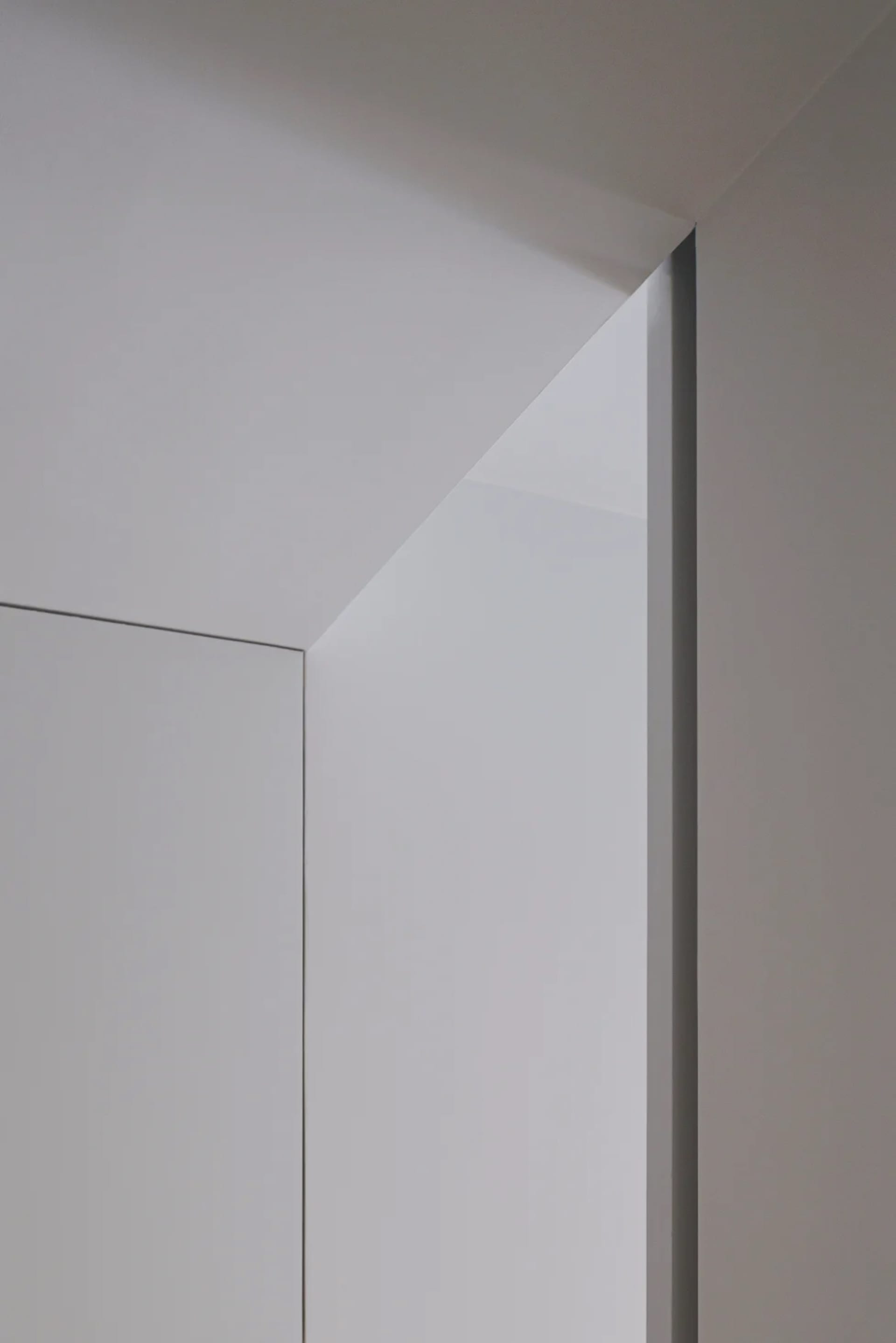 A minimalist door frame with metallic edges against a white background.