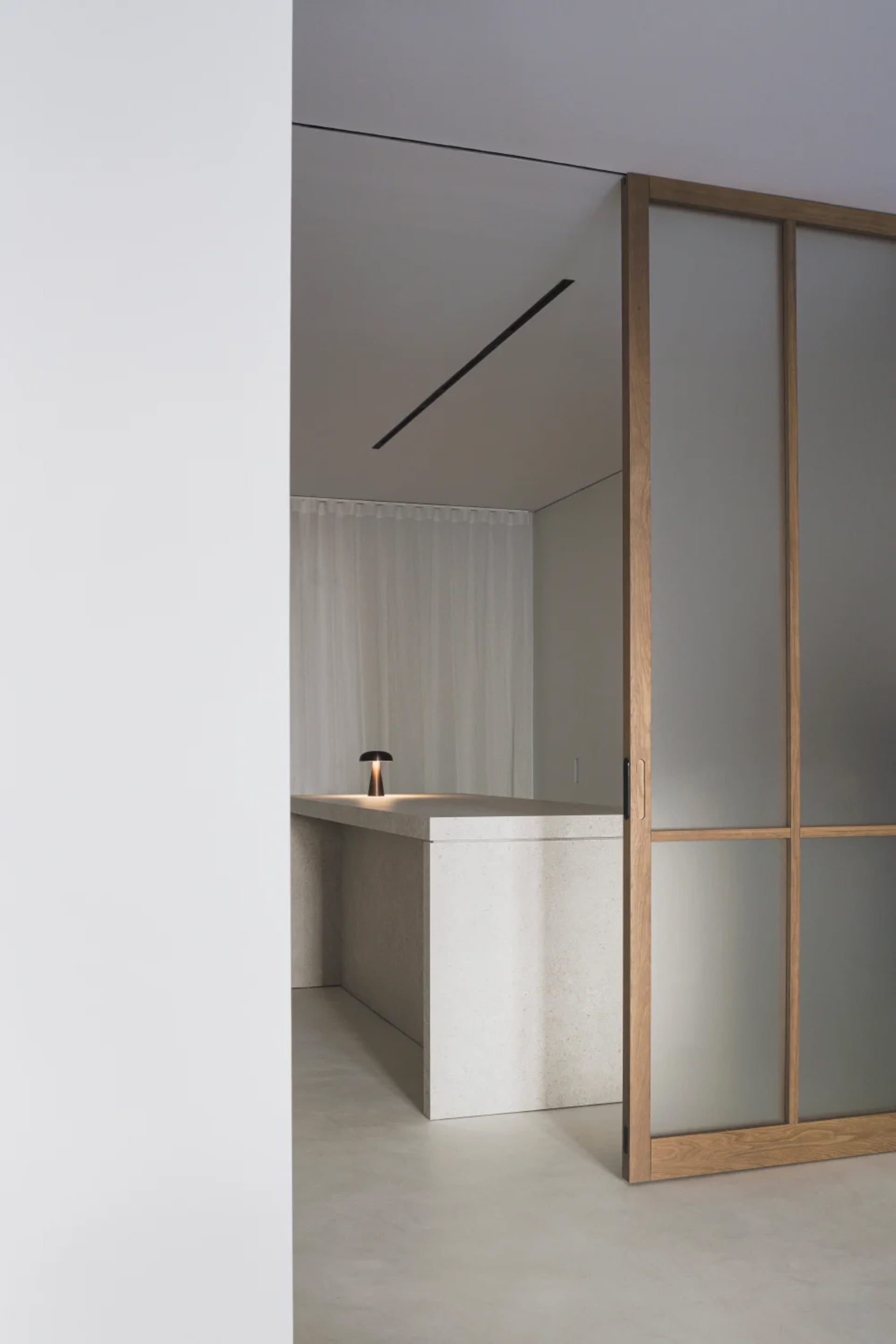 A modern kitchen with concrete countertops and a minimalist design.