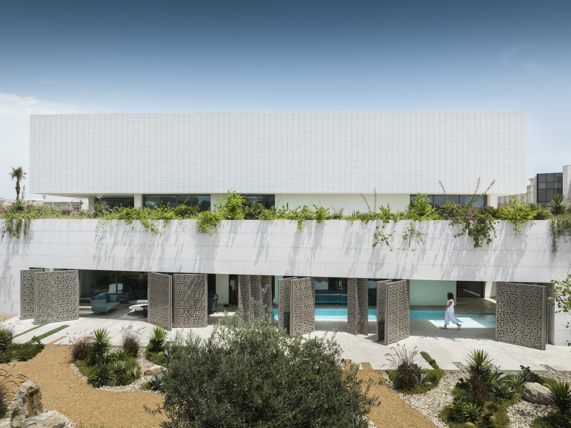 A modern residential house featuring a minimalist design with a white exterior.
