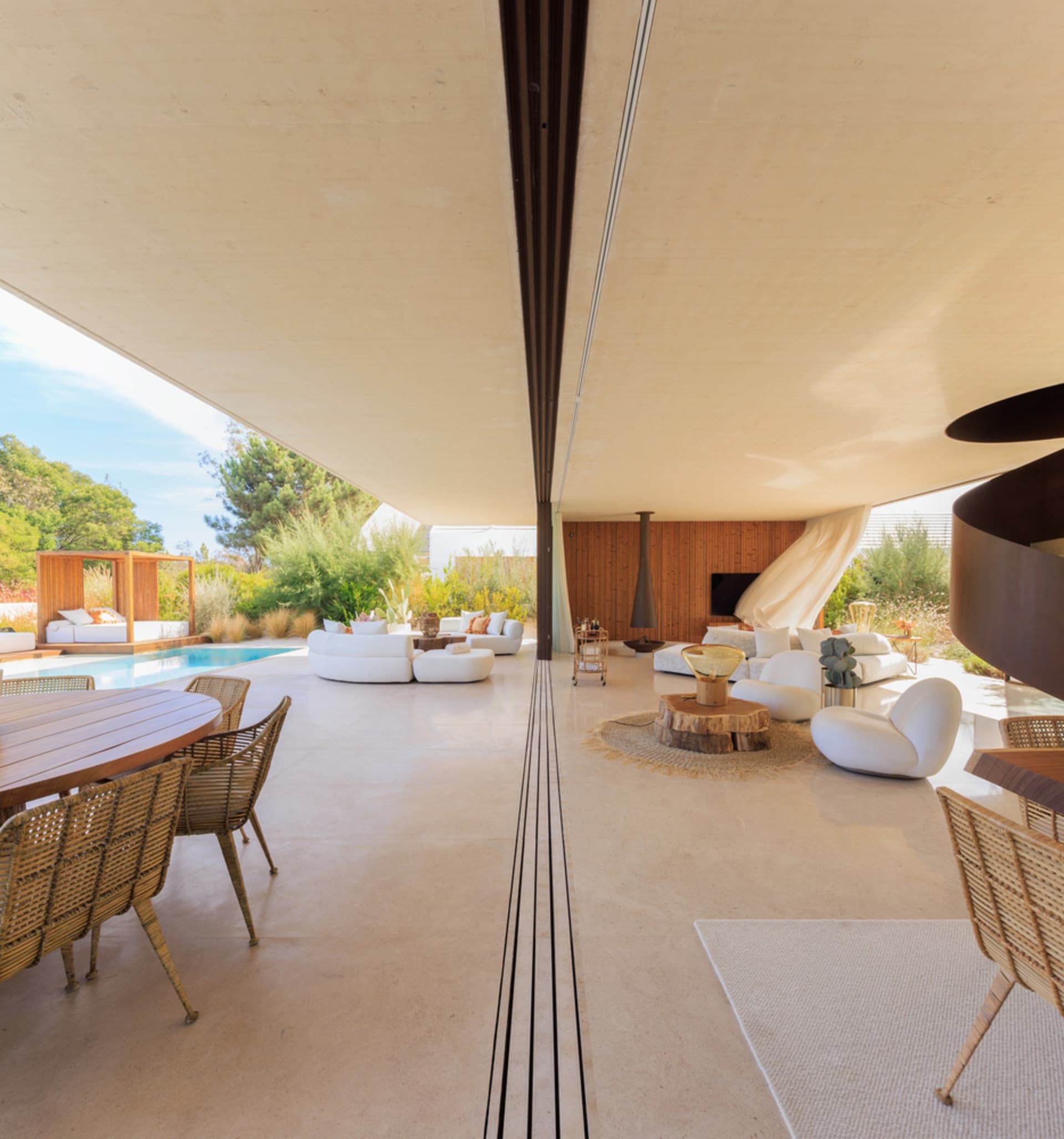 Modern minimalist living room featuring concrete, glass, and wooden elements.