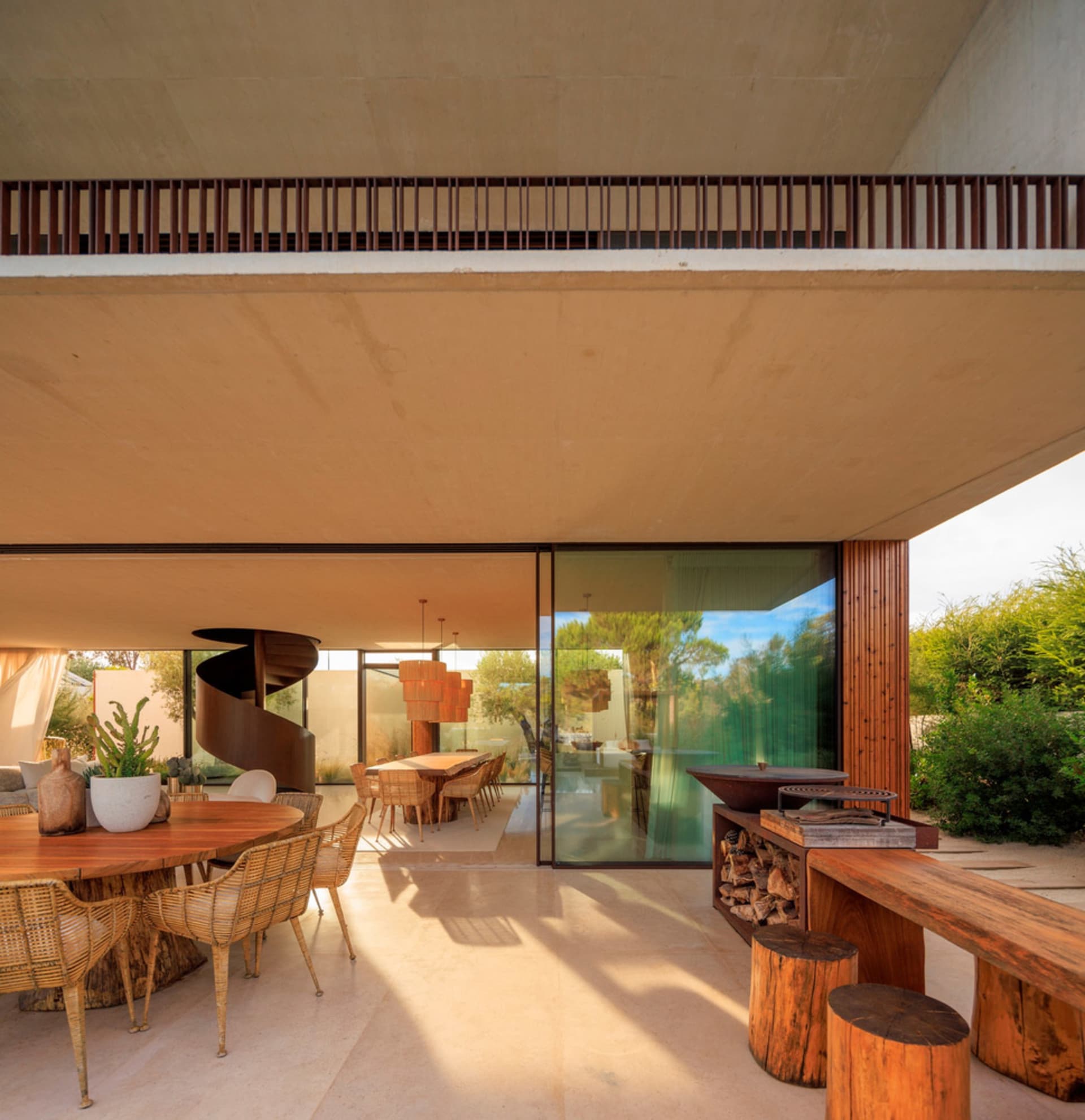 Modern residential patio featuring concrete, glass, and wooden elements.