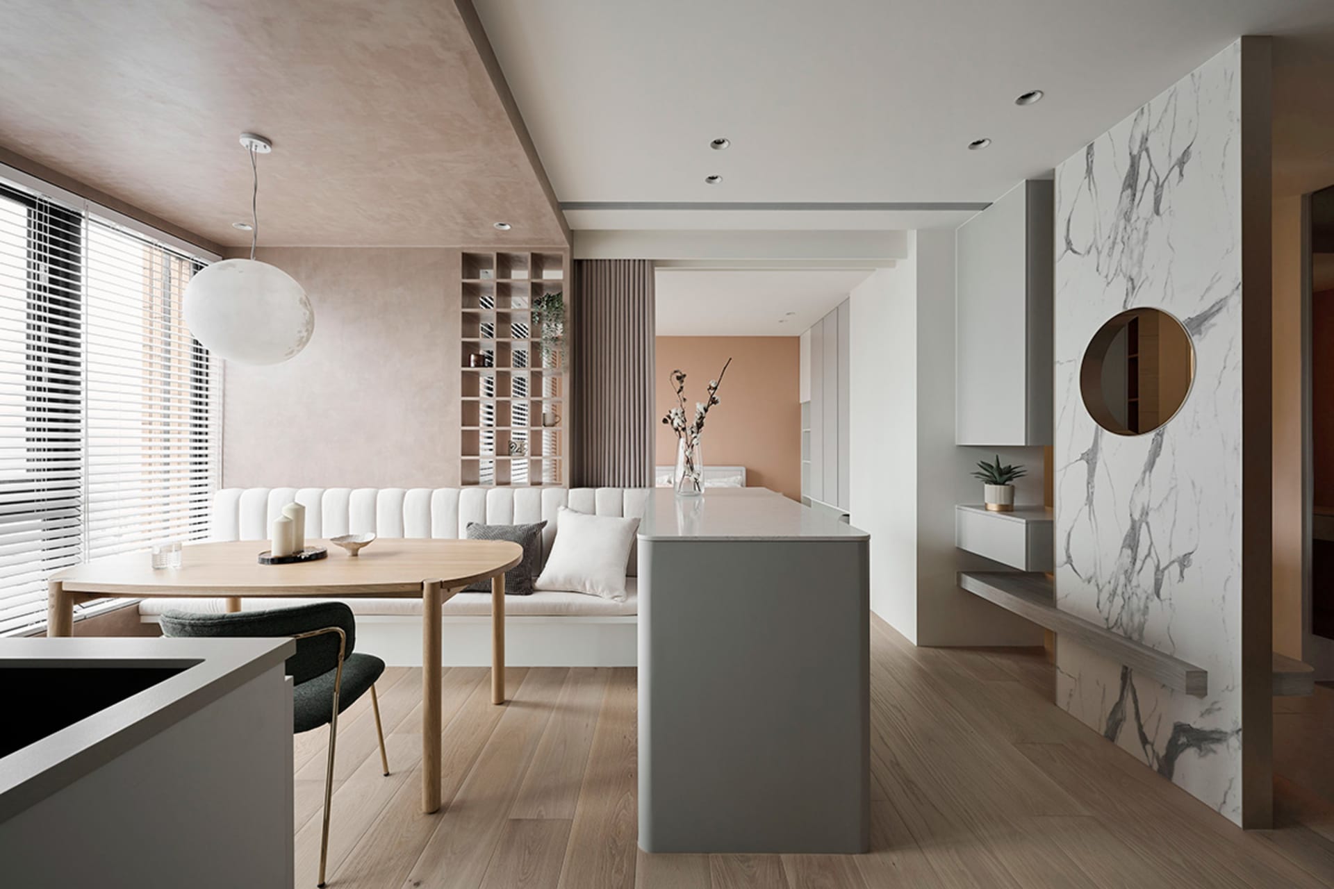 A modern interior design featuring a neutral-toned marble kitchen and living room intersection with white painted walls, mixe