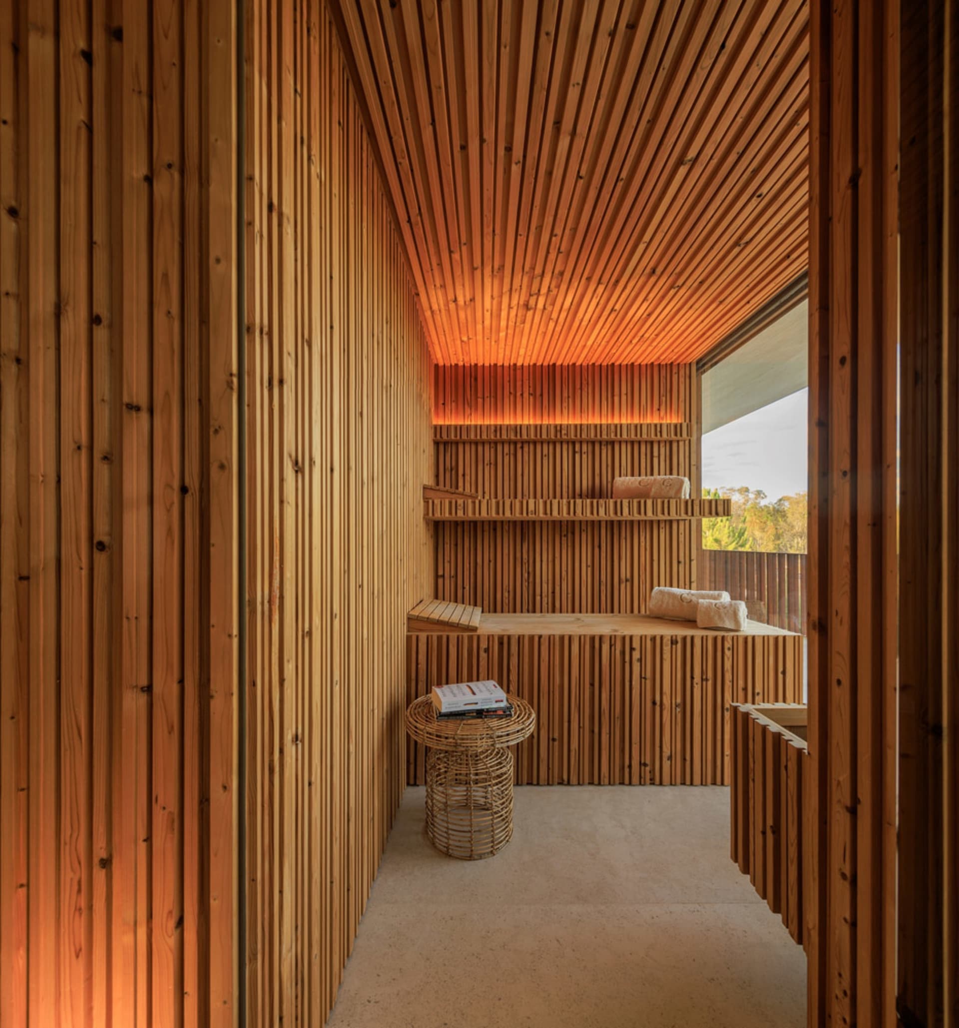 A spa room with wooden paneling, shelves, and a woven basket.