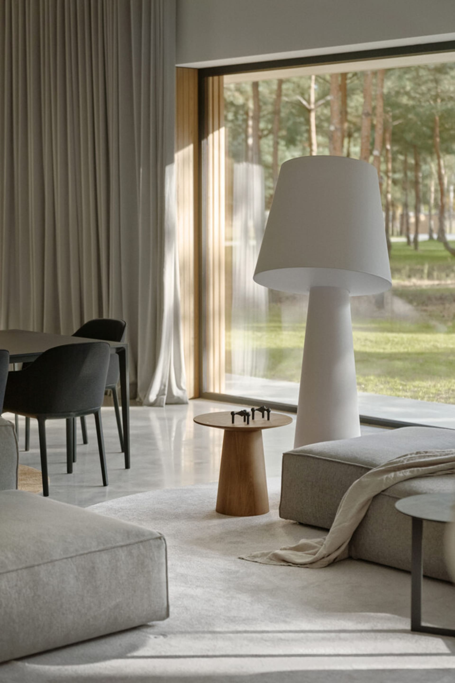 Modern living room featuring a cozy sofa, window with blinds, and natural light streaming in.