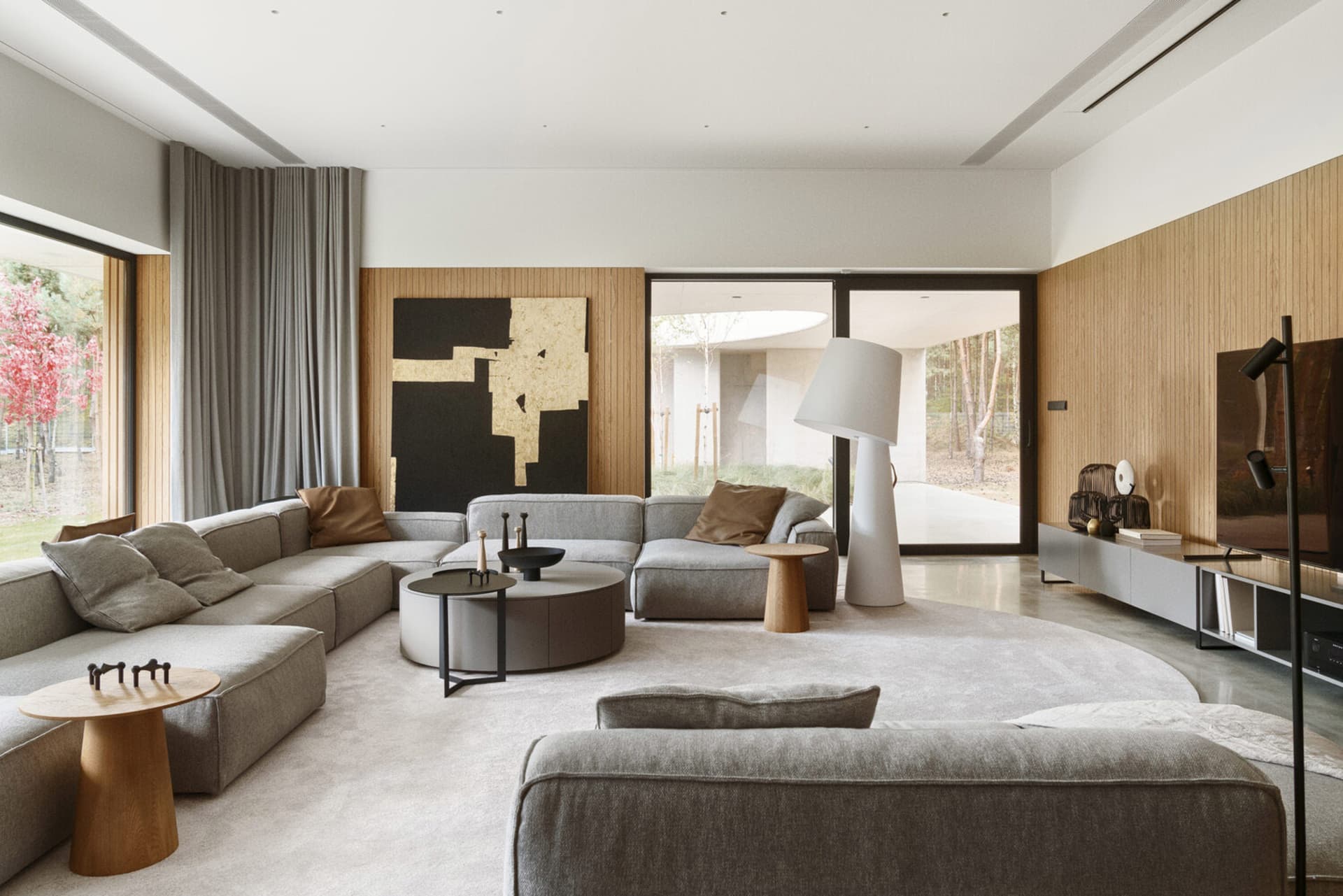 Modern minimalist living room with fabric furniture and a neutral color palette.