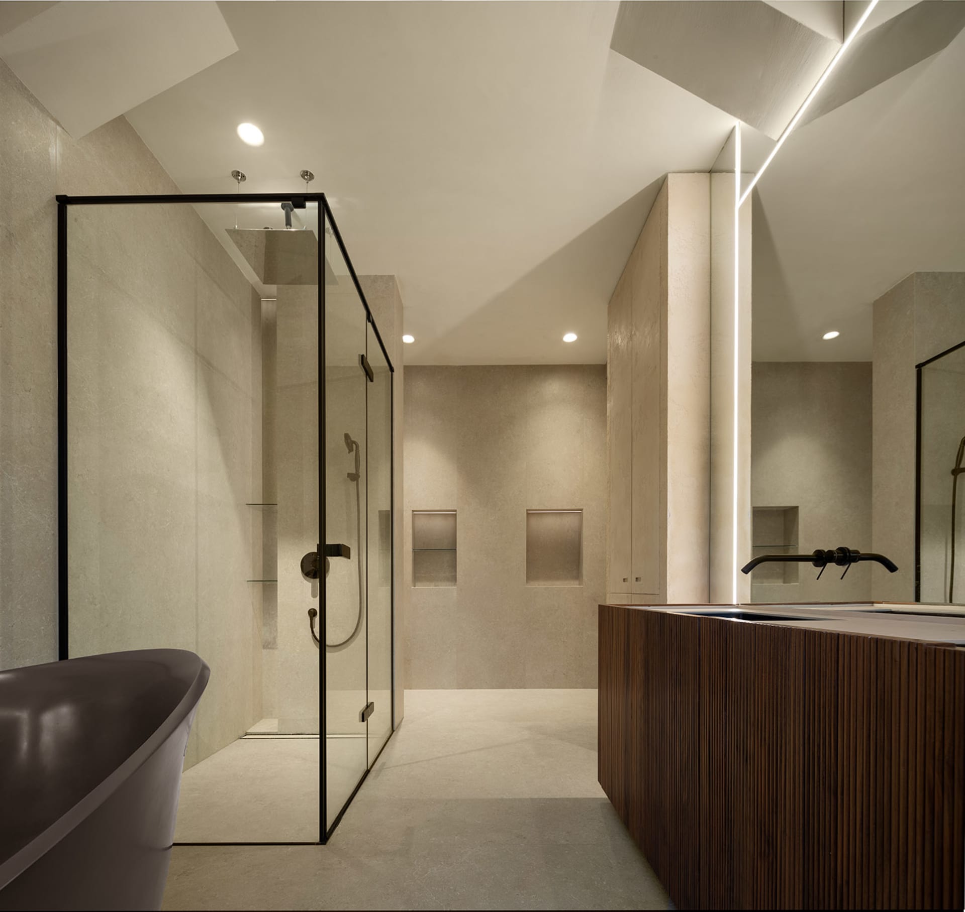 A modern industrial bathroom featuring glass shower enclosure, concrete walls, and wooden fixtures.