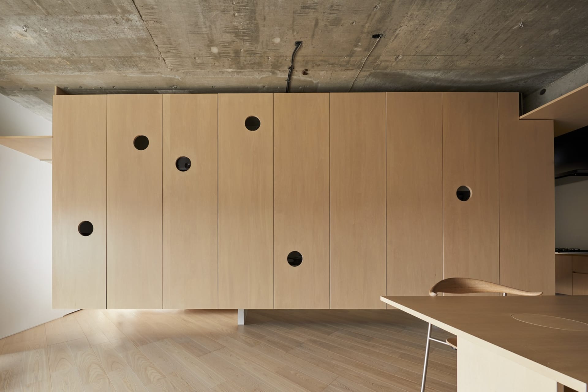 Modern interior design with wooden cabinets and concrete ceiling