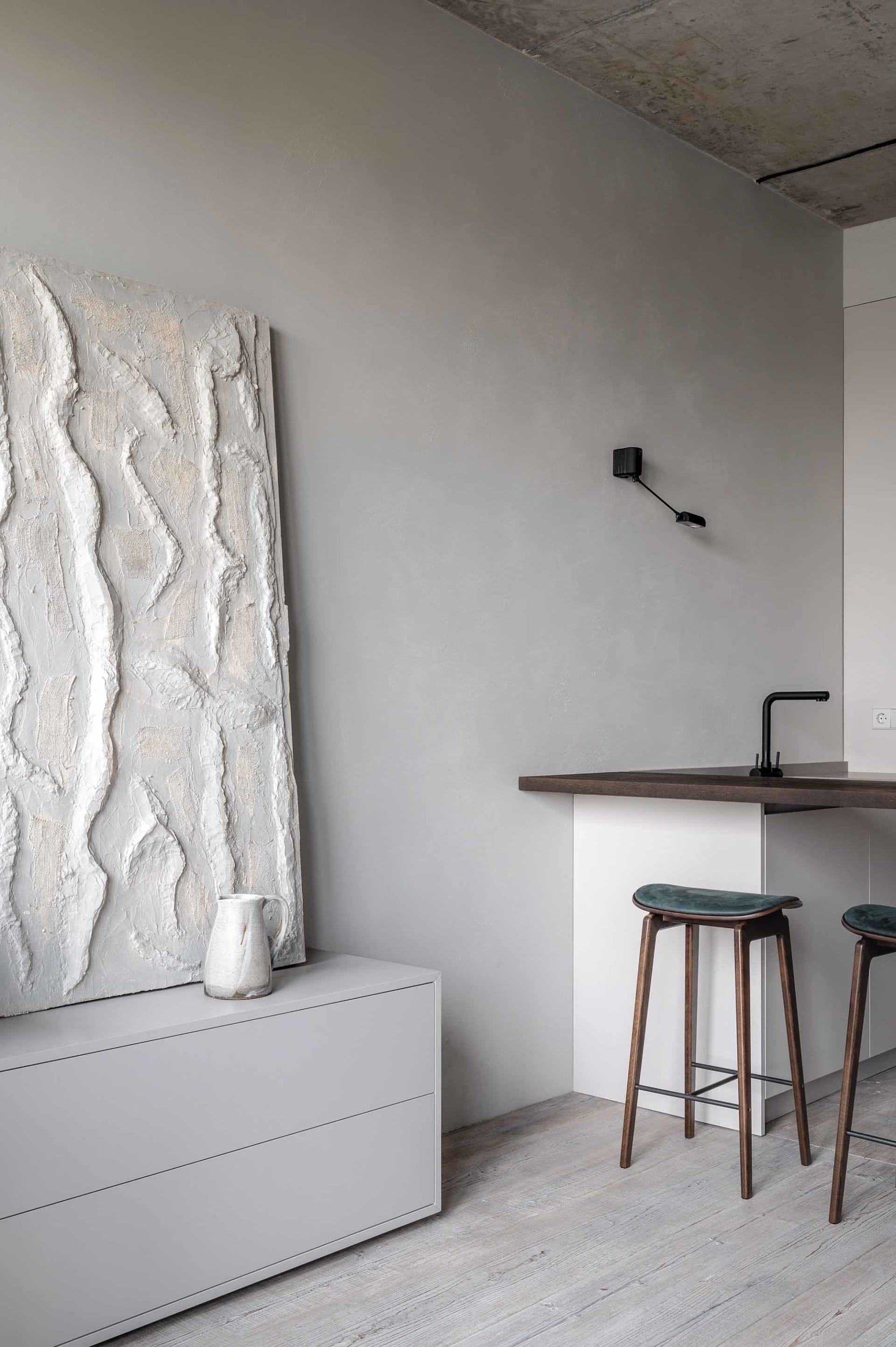 Modern residential kitchen with concrete finishes and minimalist design.