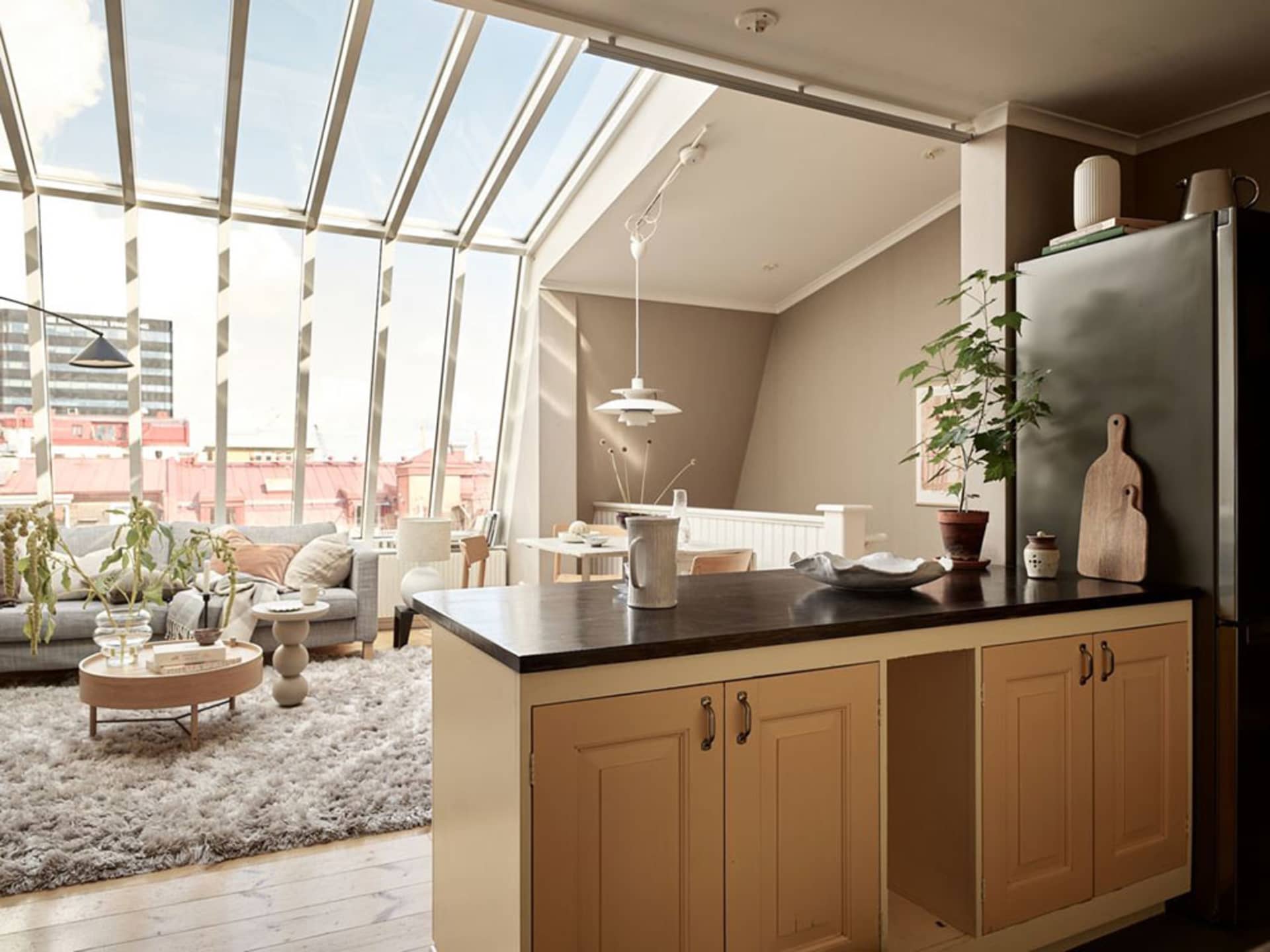 Contemporary living room featuring wooden furniture, a large window, and a comfortable seating area.